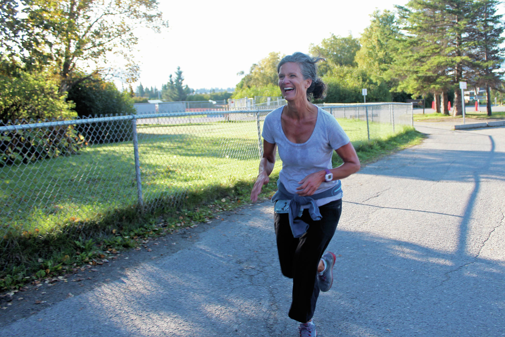 Saundra Choate-Hudson completes the running leg of the Mariner Triathlon for her team Saturday.