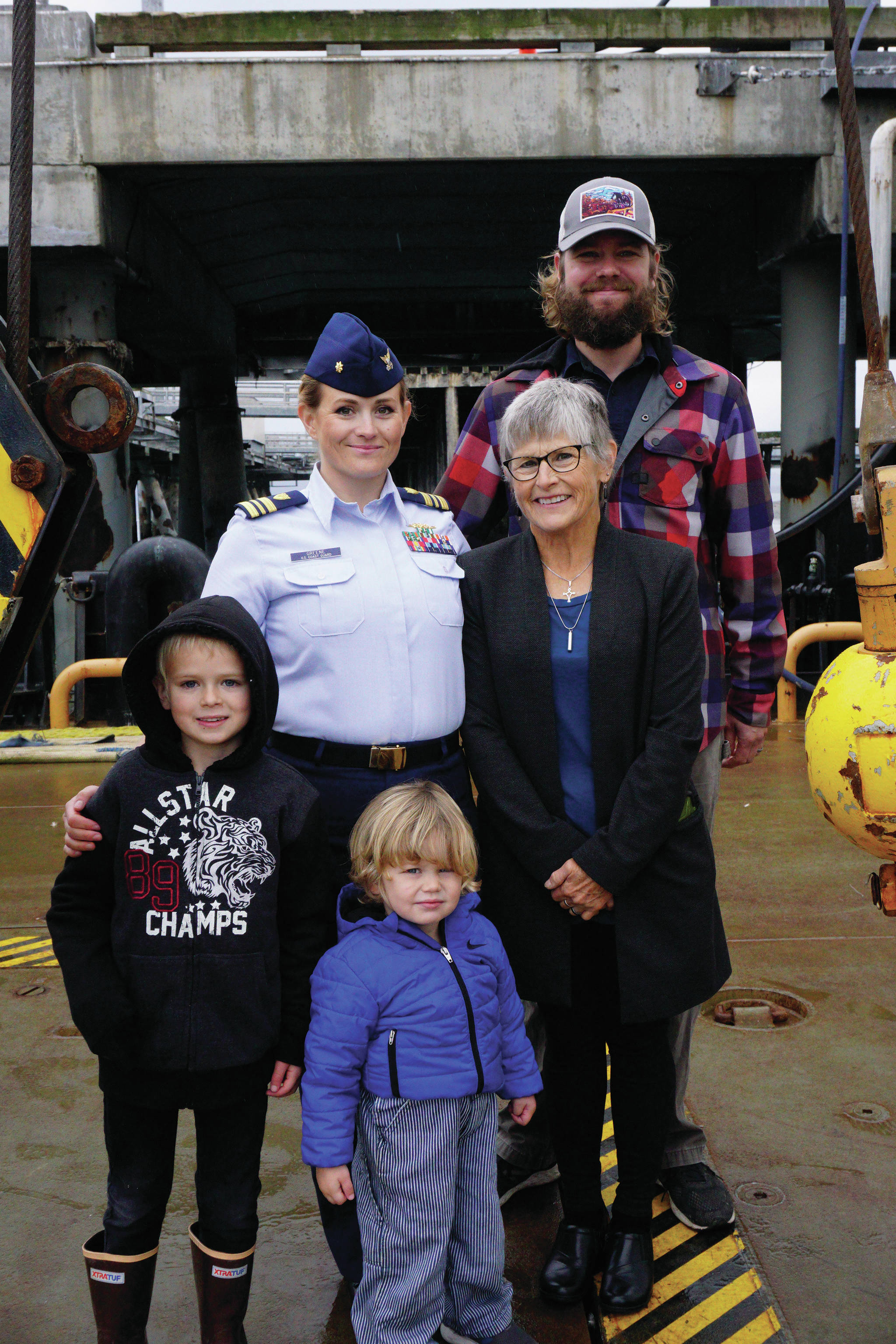 The new U.S. Coast Guard Cutter Hickory Captain, Lt. Cmdr. Jeannette M. Greene, center poses with her family on the deck of the Hickory after Greene’s assumption of command ceremony on Friday, Oct. 4, 2019, at the Pioneer Dock, in Homer, Alaska. From left to right are her sons, Grady and Sawyer, her husband, Eric, and her mother, Marian West. (Photo by Michael Armstrong/Homer News)