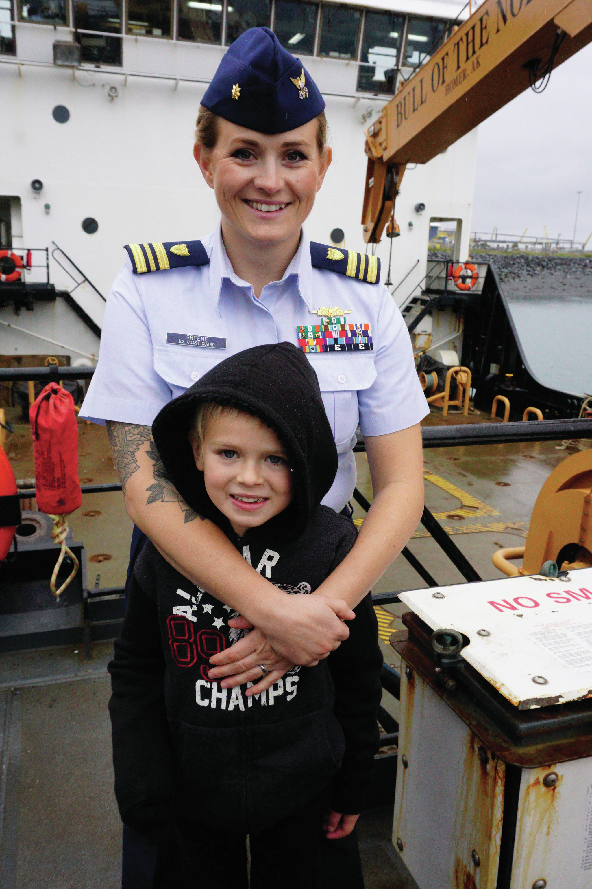 New U.S. Coast Guard Cutter Captain Lt. Cmdr. Jeannette Greene, center, poses with her son, Grady, on the deck of the Hickory after her assumption of command ceremony on Friday, Oct. 4, 2019, at the Pioneer Dock in Homer, Alaska. (Photo by Michael Armstrong/Homer News)