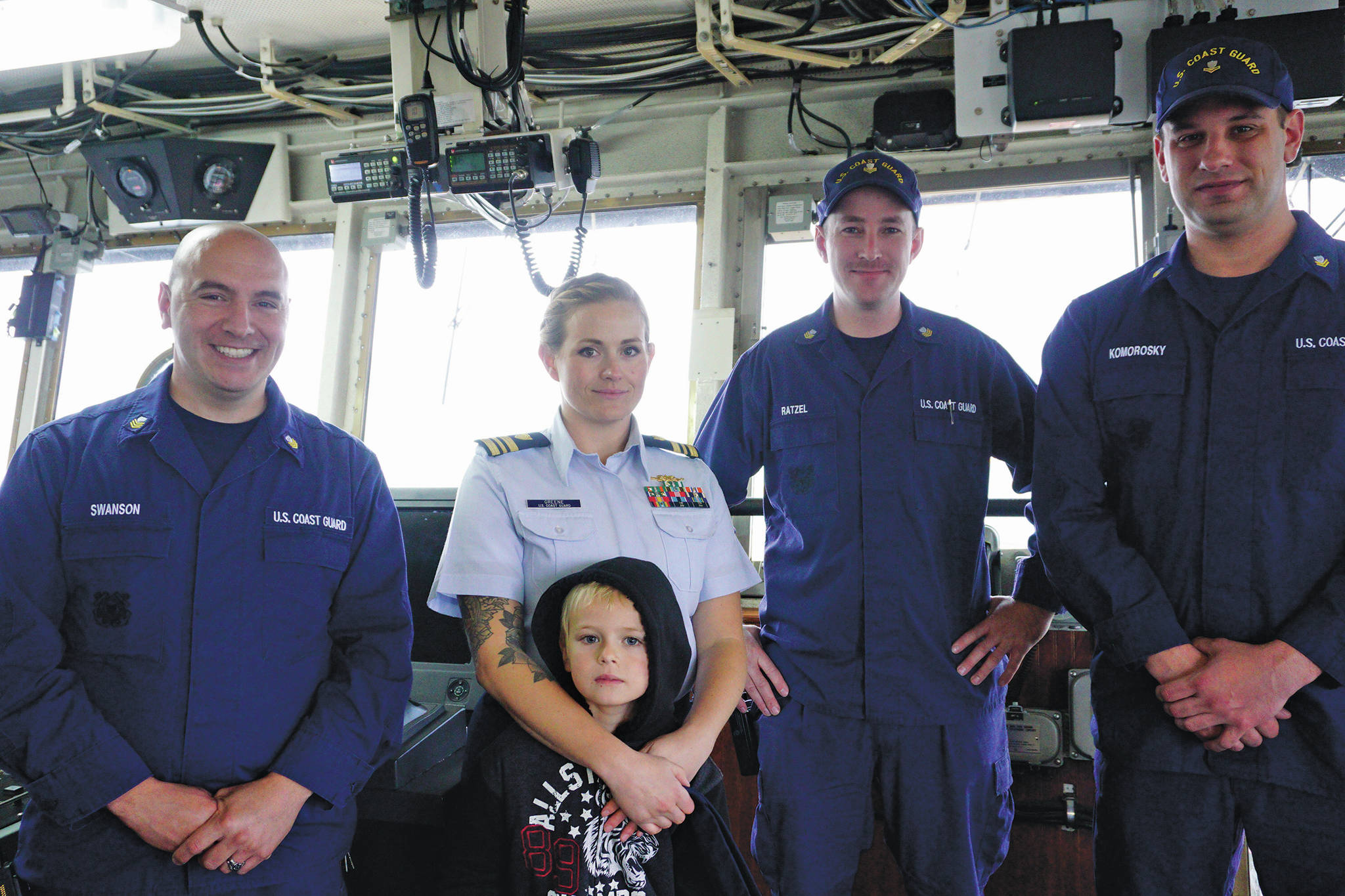 The new U.S. Coast Guard Cutter Hickory Captain, Lt. Cmdr. Jeannette M. Greene, poses with her son, Grady, and crewmates, from left to right, Petty Officer 1st Class Jon Swanson, Petty Officer 1st Class Dermont Ratzel, and Petty Officer 2nd Class Carl Komorosky, after Greene’s assumption of command ceremony on Friday, Oct. 4, 2019, at the Pioneer Dock, in Homer, Alaska. (Photo by Michael Armstrong/Homer News)