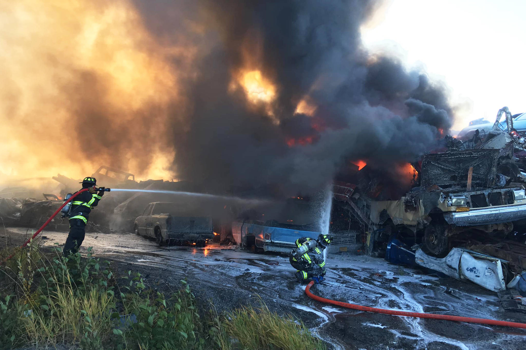 Firefighters work to extinguish a fire in a pile of scrap vehicles on Greenfield Road on Sunday, Oct. 6, 2019 in Anchor Point, Alaska. (Photo courtesy Anchor Point Fire and Emergency Services)