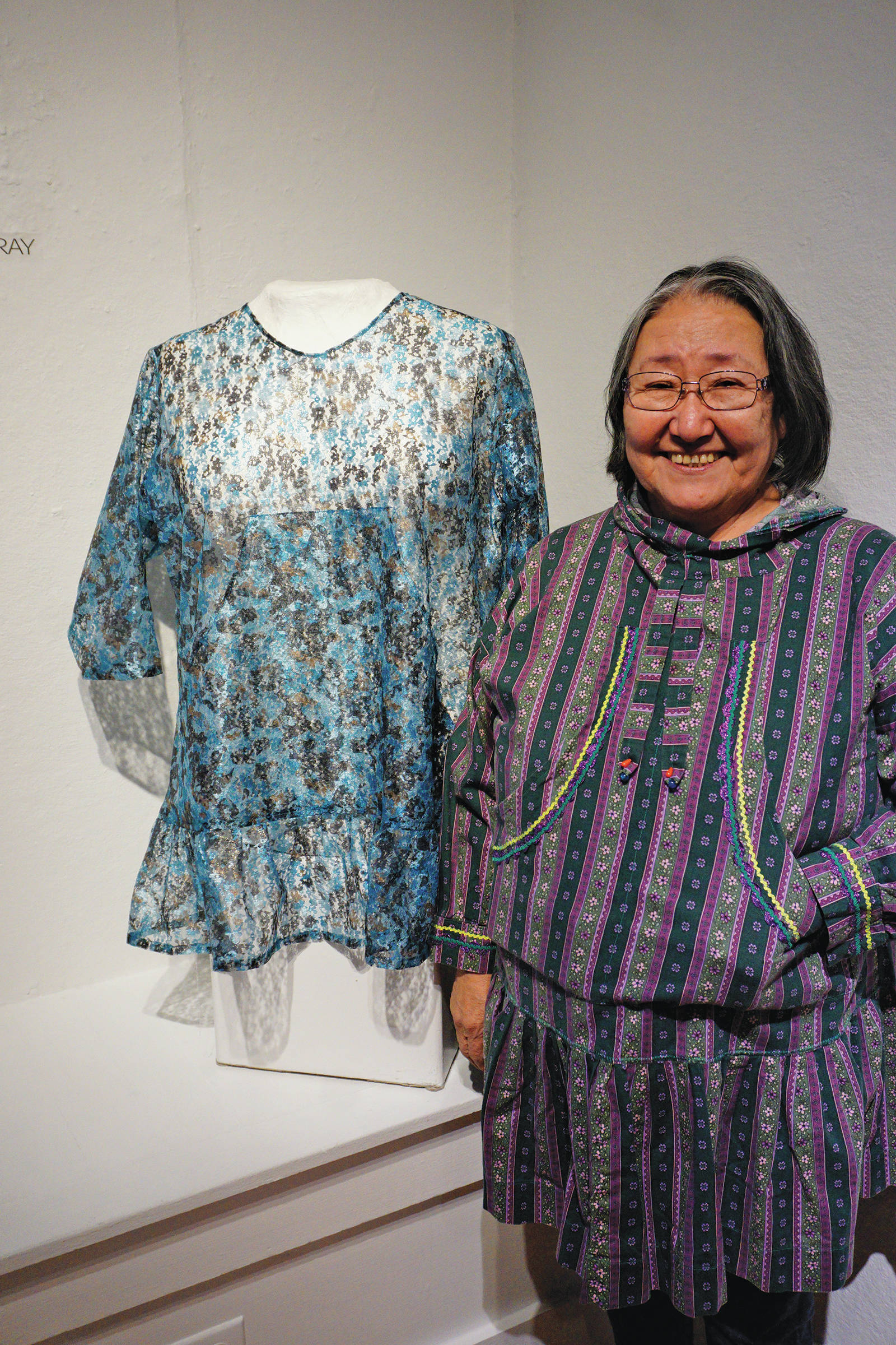 Homer artist Martha Murray stands by her kuspuk at the opening of the “Kuspuk/Qaspeq/Atikluk” show on Oct. 5, 2019, at Bunnell Street Arts Center in Homer, Alaska. (Photo by Michael Armstrong/Homer News)