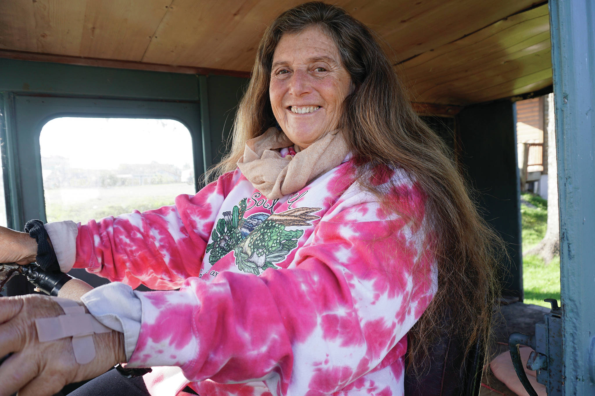 Donna Maltz poses in the original Fresh Sourdough Express Bakery and Cafe van on Sept. 27, 2019, as the landmark business held a going-out-of-business garage sale at its Ocean Drive location in Homer, Alaska. (Photo by Michael Armstrong/Homer News)