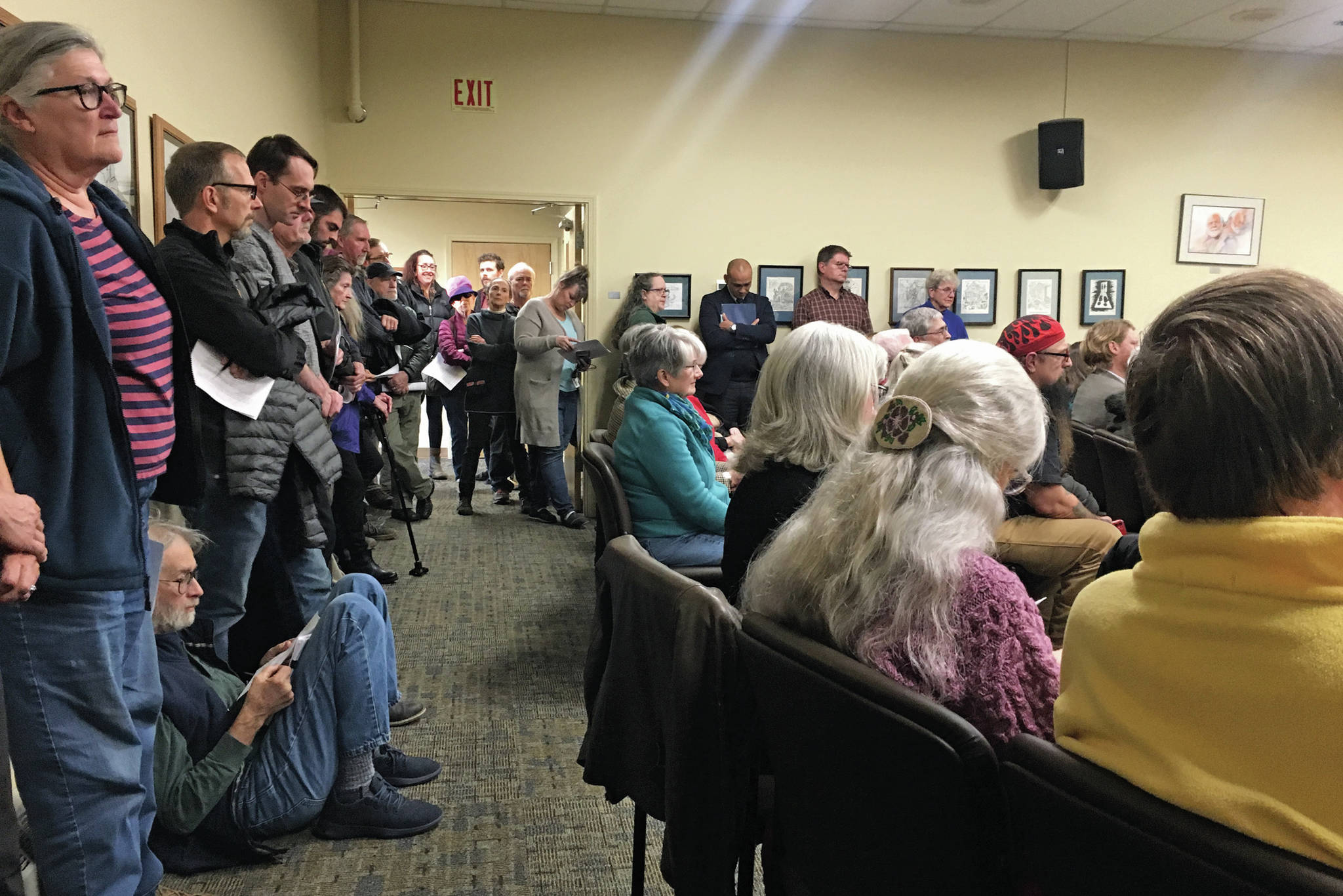 Community members pack into a standing room only city council chambers Monday, Oct. 14, 2019 for a council meeting in Homer City Hall in Homer, Alaska. (Photo by Megan Pacer/Homer News)