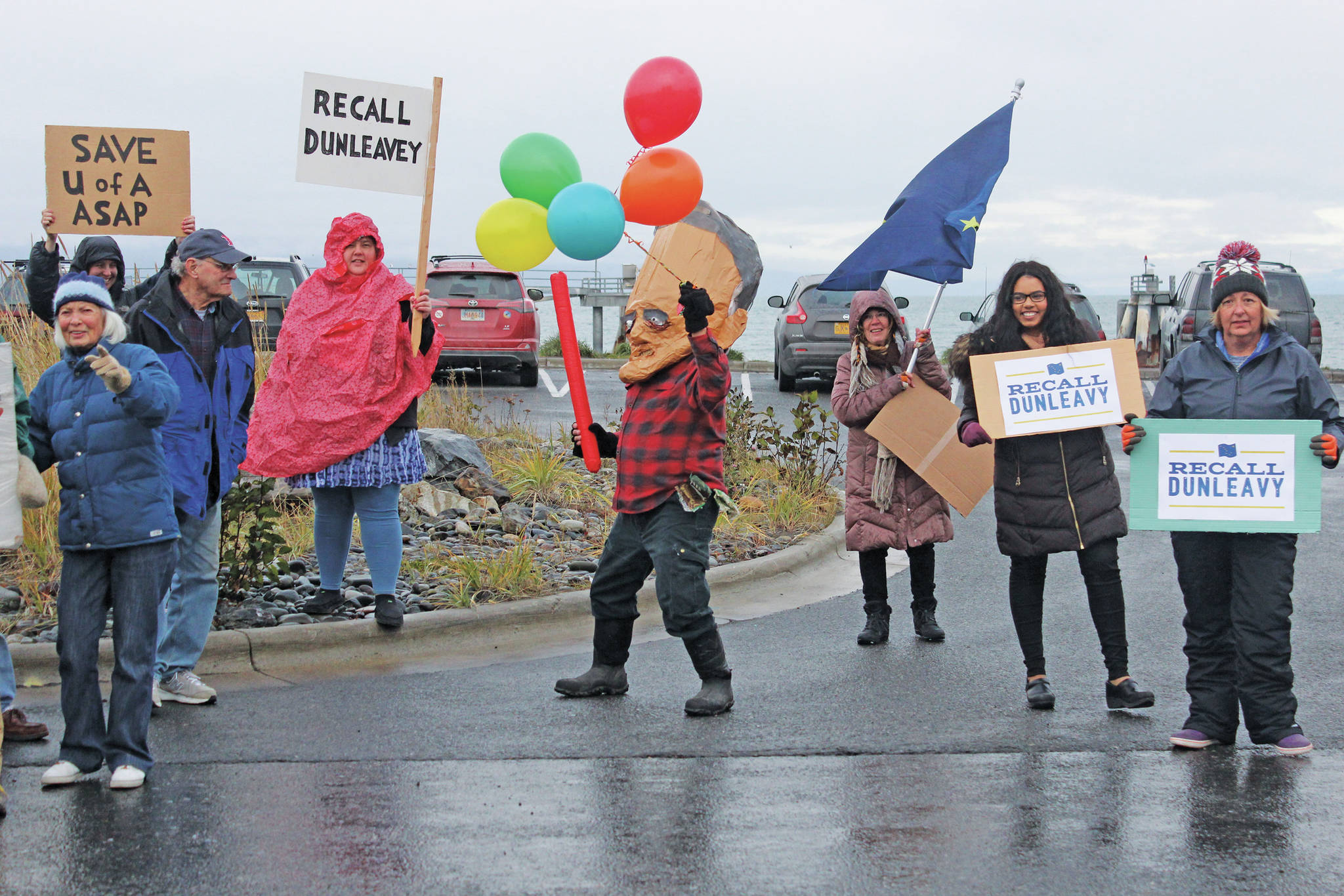 Local supporters of the effort to recall Gov. Mike Dunleavy protest outside the Land’s End Resort where he gave a brief presentation on the statewide economy at a conference held by the Alaska State Home Building Association and the Kenai Peninsula Home Builders Association on Thursday, Oct. 17, 2019 in Homer, Alaska. (Photo by Megan Pacer/Homer News)