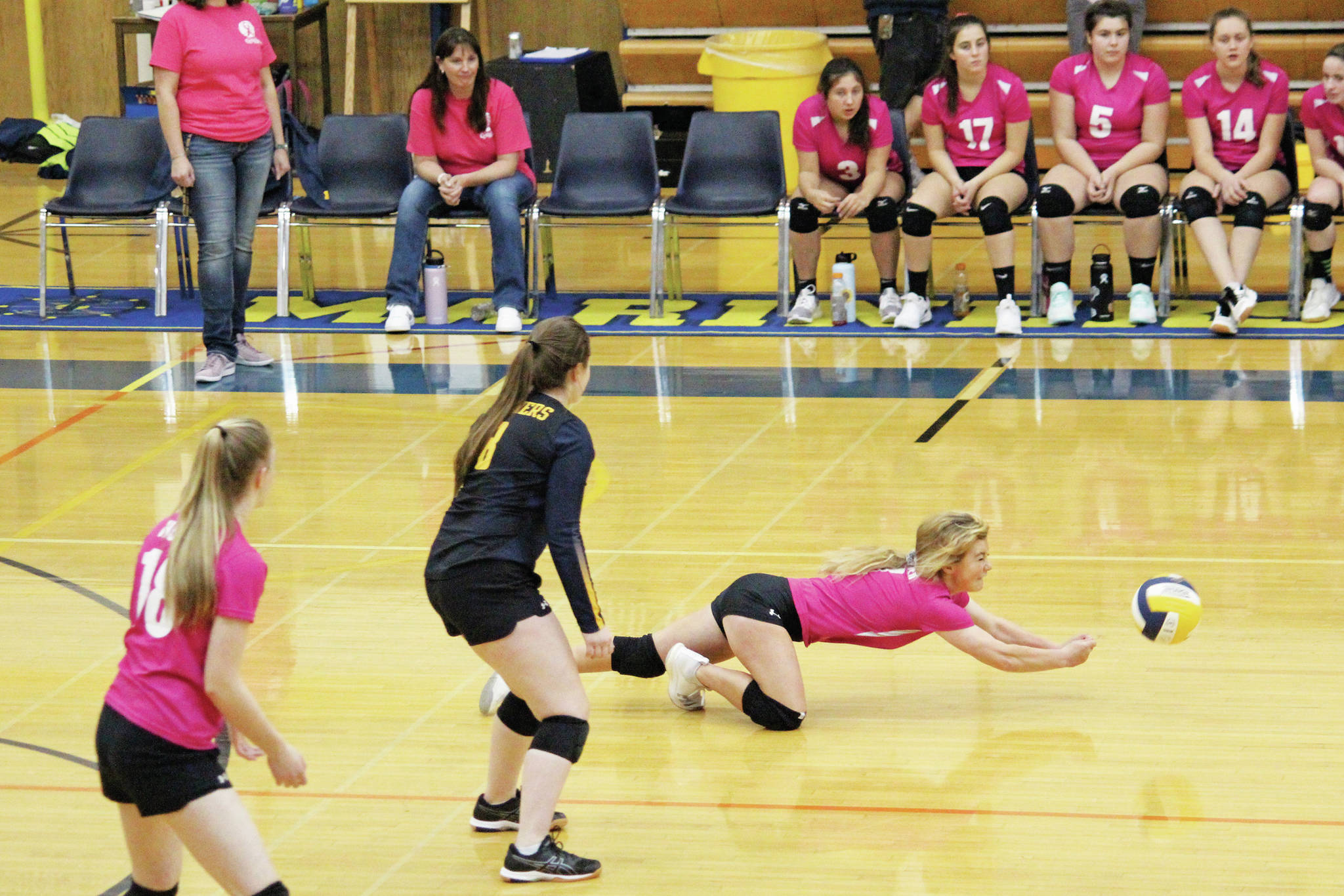 Homer’s Sela Weisser dives for the ball during a Friday, Oct. 18, 2019 volleyball game against Seward High School in the Alice Witte Gymnaisum in Homer, Alaska. (Photo by Megan Pacer/Homer News)
