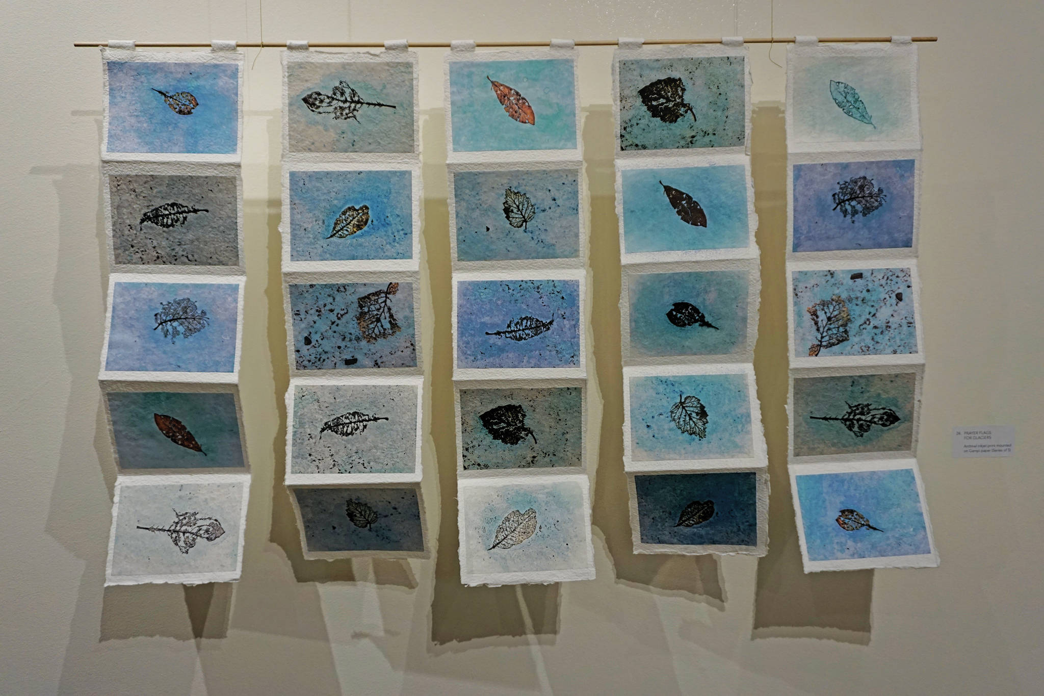 Kathy Smith’s “Prayer Flags for Glaciers,” a series of prints in her exhibit, “Rivers of Ice,” showing at the Pratt Museum through Dec. 28. 2019, in Homer, Alaska. (Photo by Michael Armstrong/Homer News)