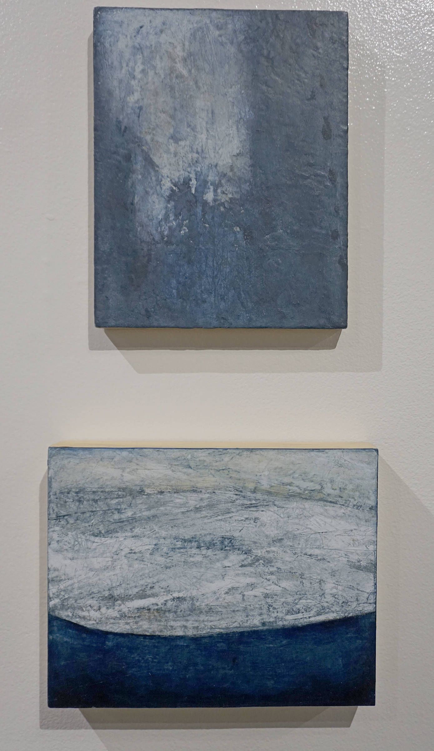 Kathy Smith’s “Glacier Color Study 1,” top, and “Glacier Color Study 2,” bottom, two paintings in her exhibit, “Rivers of Ice,” showing at the Pratt Museum in Homer, Alaska. (Photo by Michael Armstrong/Homer News)