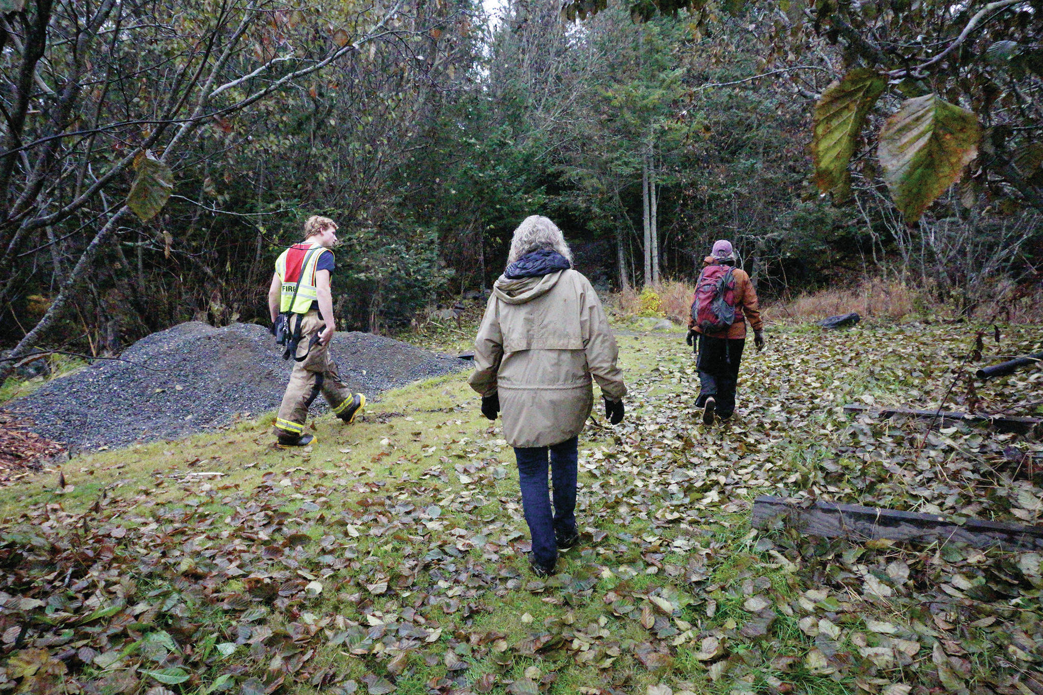 Casey Fetterhoff, left, with the Homer Volunteer Fire Department, leads a search on Sunday, Oct. 20, 2019, off Main Street and Pioneer Avenue for Anesha “Duffy” Murnane, a Homer woman missing since Thursday, Oct. 17, 2019, in Homer, Alaska. (Photo by Michael Armstrong/Homer News)