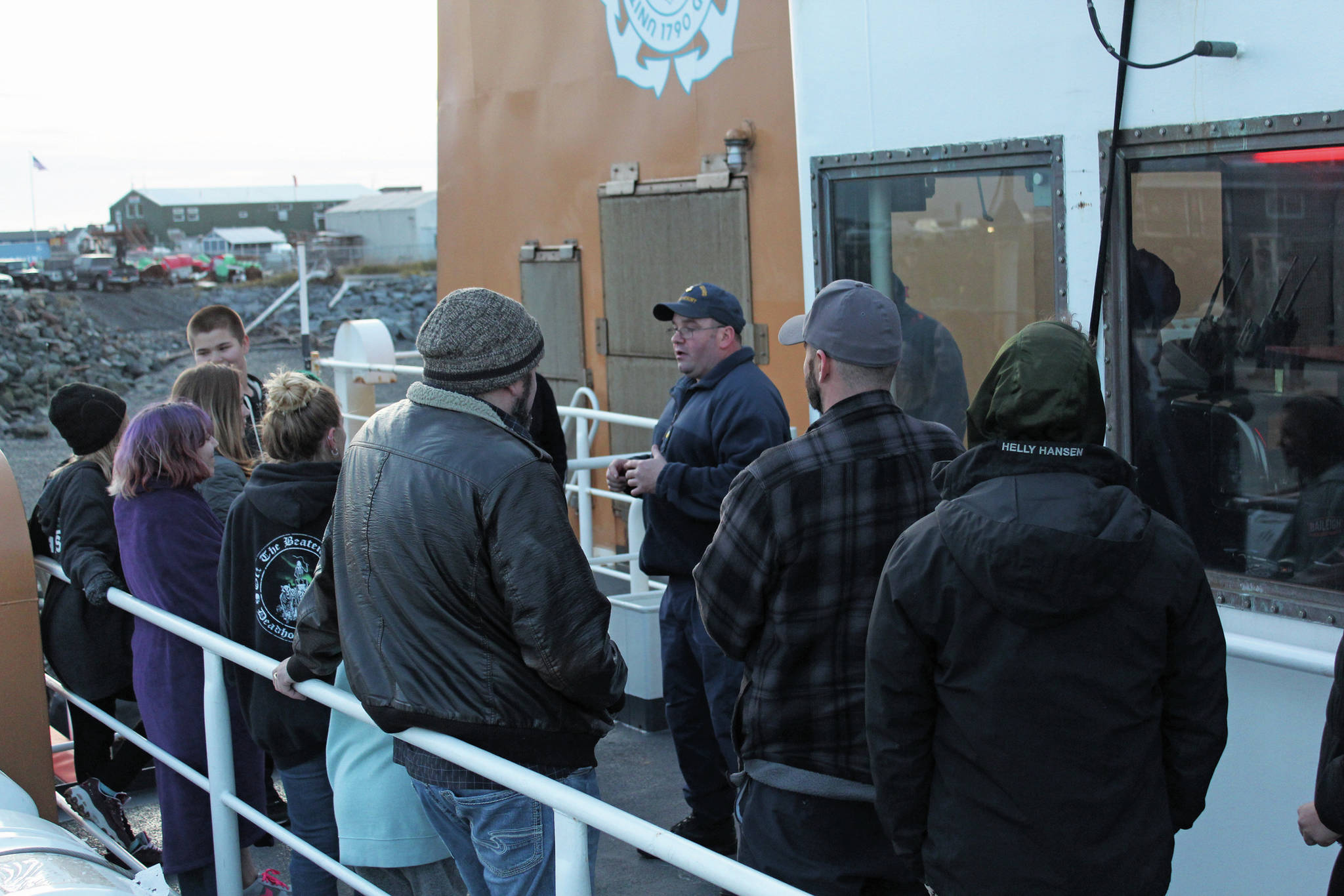A group of community members gets briefs before they embark on a trip through the Haunted Hickory, a haunted house set up on the US Coast Guard Cutter Hickory vessel, on Friday, Oct. 25, 2019 at the harbor in Homer, Alaska. (Photo by Megan Pacer/Homer News)