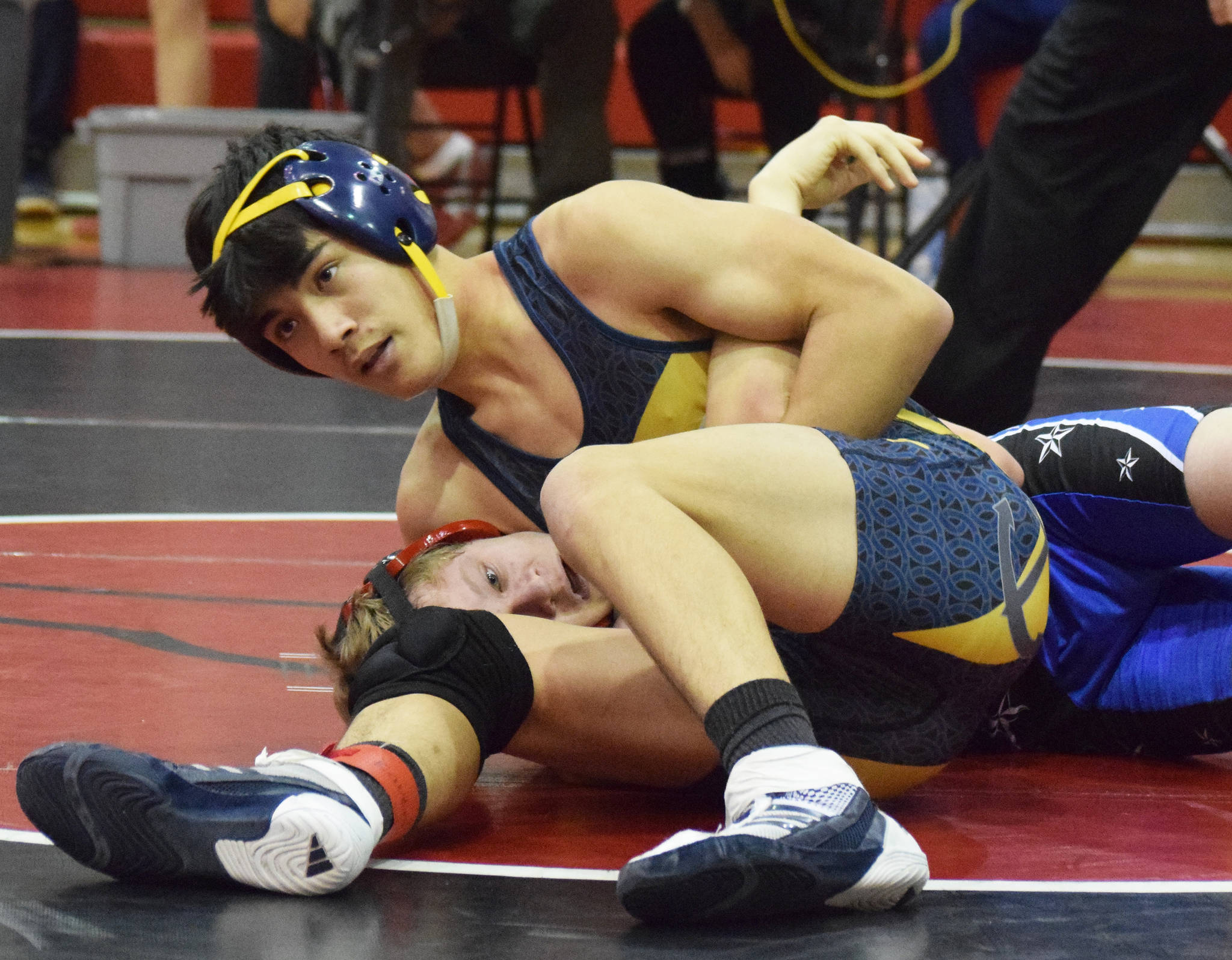 Homer’s Russell Nyvall grabs Soldotna’s Peyton Lawton in a headlock Saturday at the Luke Spruill Memorial Tournament at Kenai Central High School in Kenai. (Photo by Joey Klecka/Peninsula Clarion)