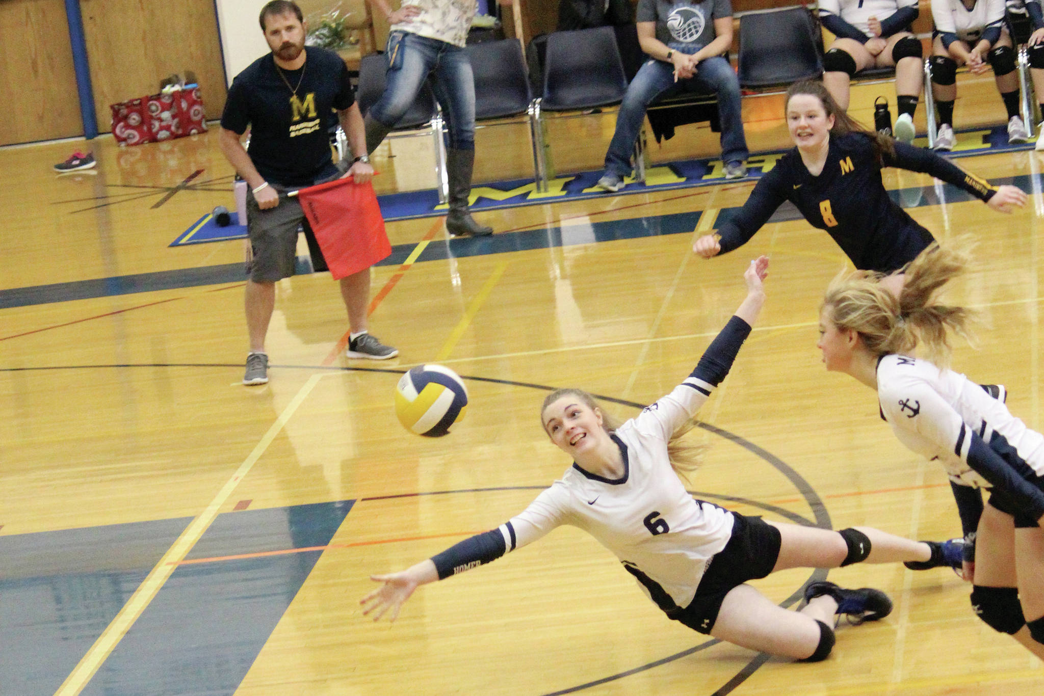 Homer’s Karmyn Gallios dives for the ball during a Tuesday, Oct. 29, 2019 volleyball game against Kenai Central High School in the Alice Witte Gymnasium in Homer, Alaska. (Photo by Megan Pacer/Homer News)
