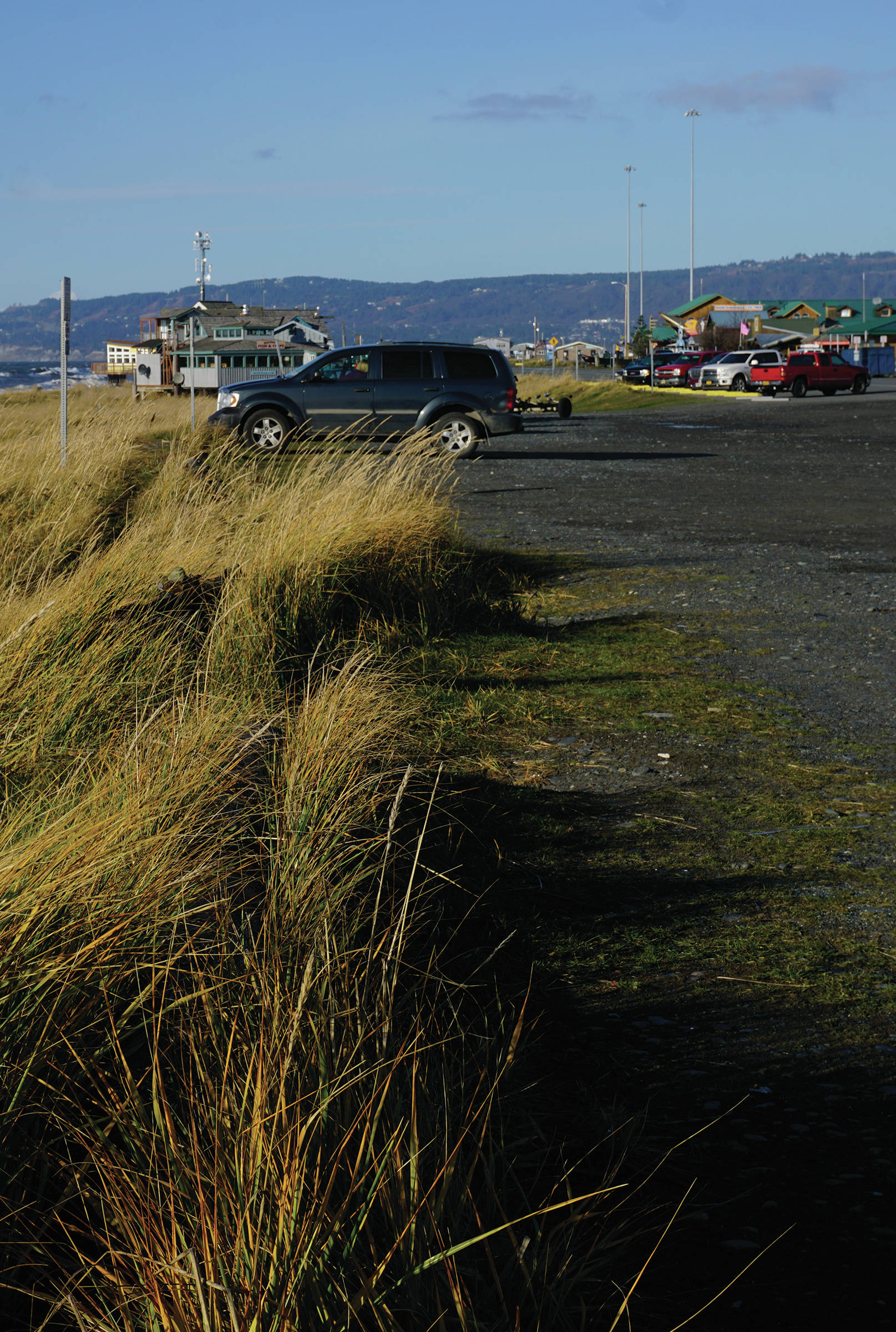 The Seafarers Memorial parking lot is mostly empty on Oct. 25, 2019, on the Homer Spit in Homer, Alaska. The city has applied for a conditional use permit to fill in and extend the parking lot to the left in this photo, or toward the beach. The angled parking spaces by the Homer Spit Road also would be removed except in front of the Cannery Row Boardwalk. (Photo by Michael Armstrong/Homer News)