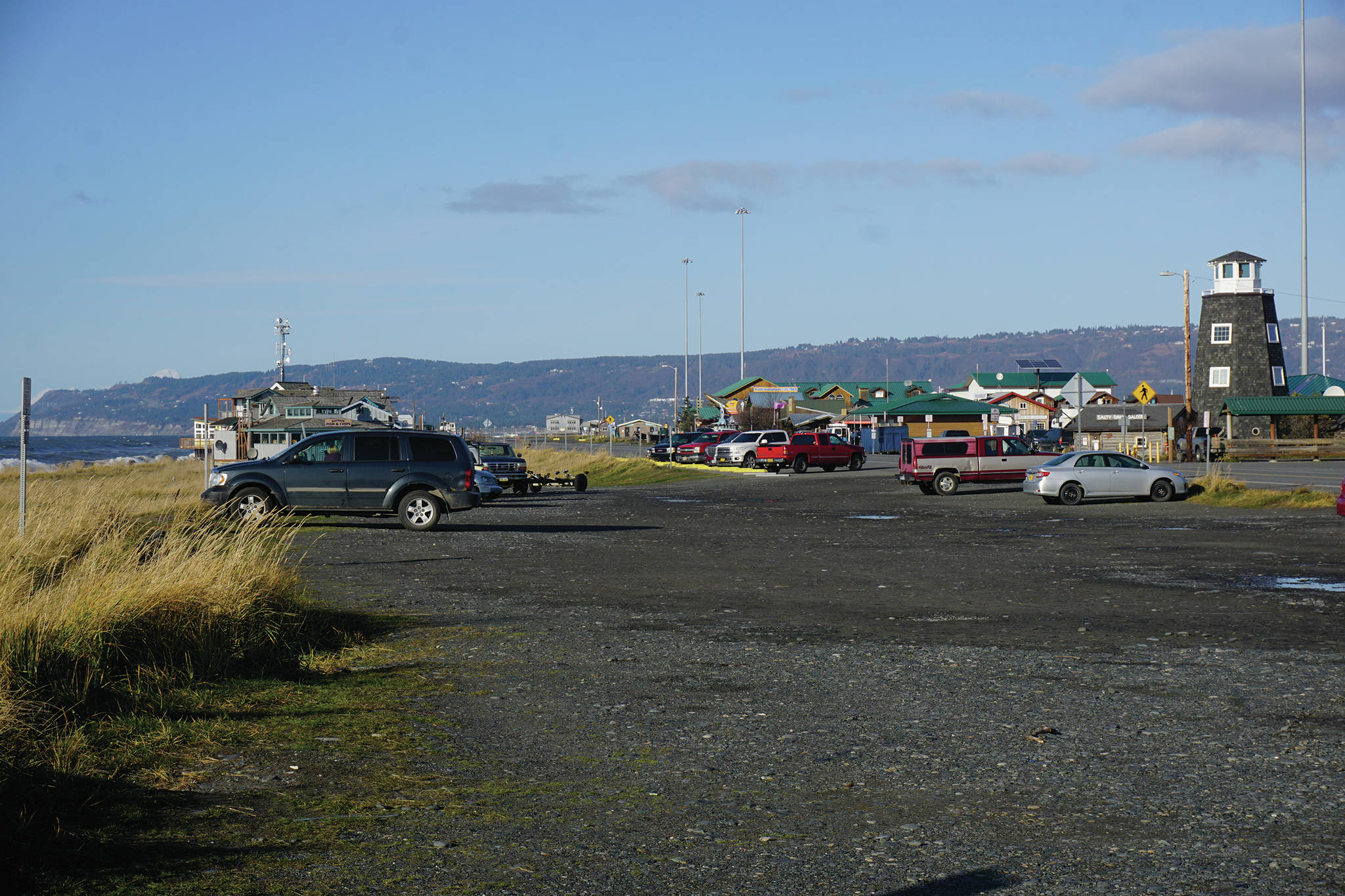 The Seafarers Memorial parking lot is mostly empty on Oct. 25, 2019, on the Homer Spit in Homer, Alaska. The city has applied for a conditional use permit to fill in and extend the parking lot to the left in this photo, or toward the beach. The angled parking spaces by the Homer Spit Road also would be removed except in front of the Cannery Row Boardwalk.(Photo by Michael Armstrong/Homer News)