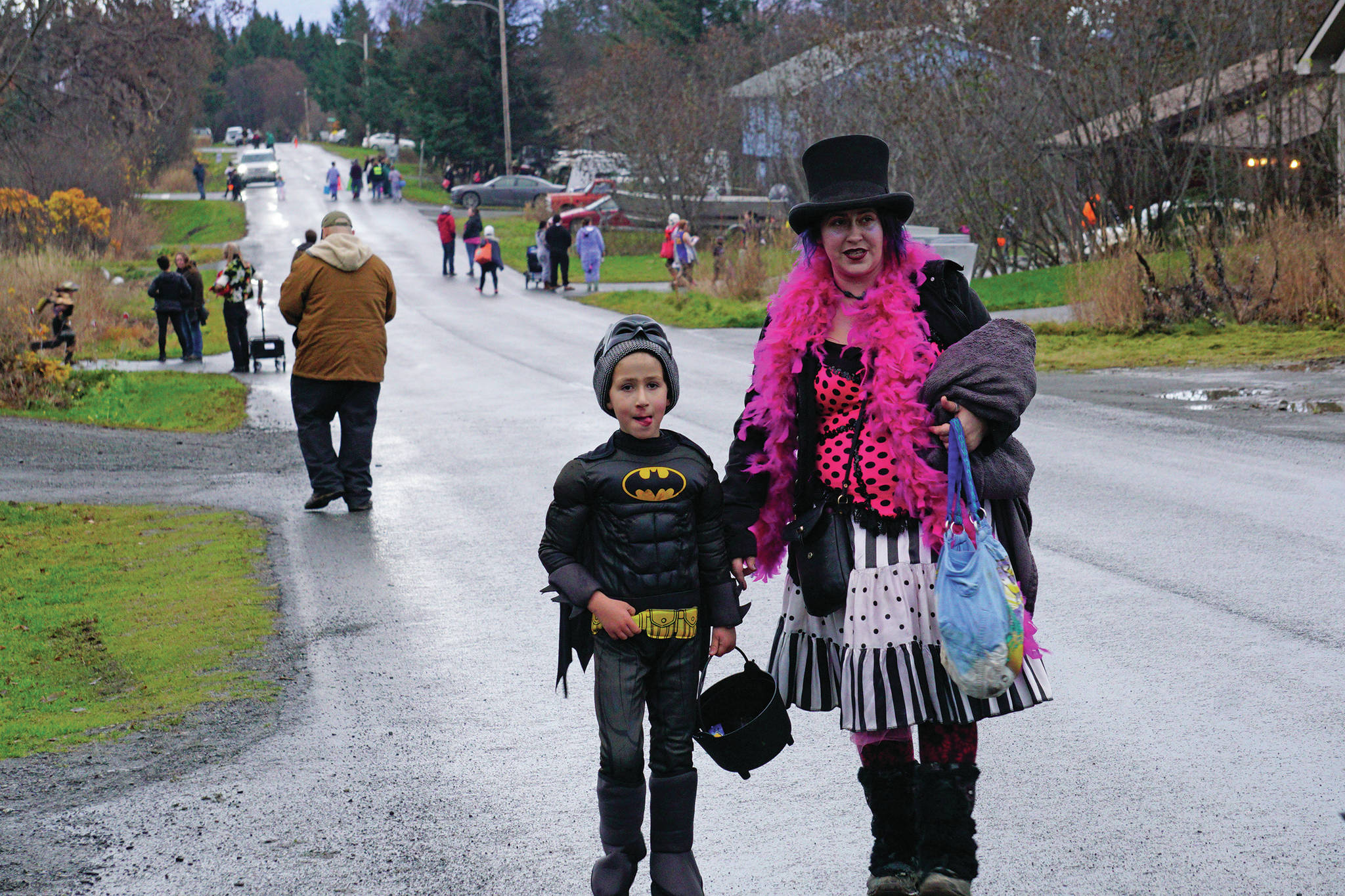 Soren Thomas, left, and his mom, Sage, right, were part of a group of Halloween trick-or-treaters walking down Bayview Avenue, on Oct. 31, 2019, in Homer, Alaska. Bayview Avenue and Mountainview Avenue were one-way for the night to minimize traffic. (Photo by Michael Armstrong/Homer News)