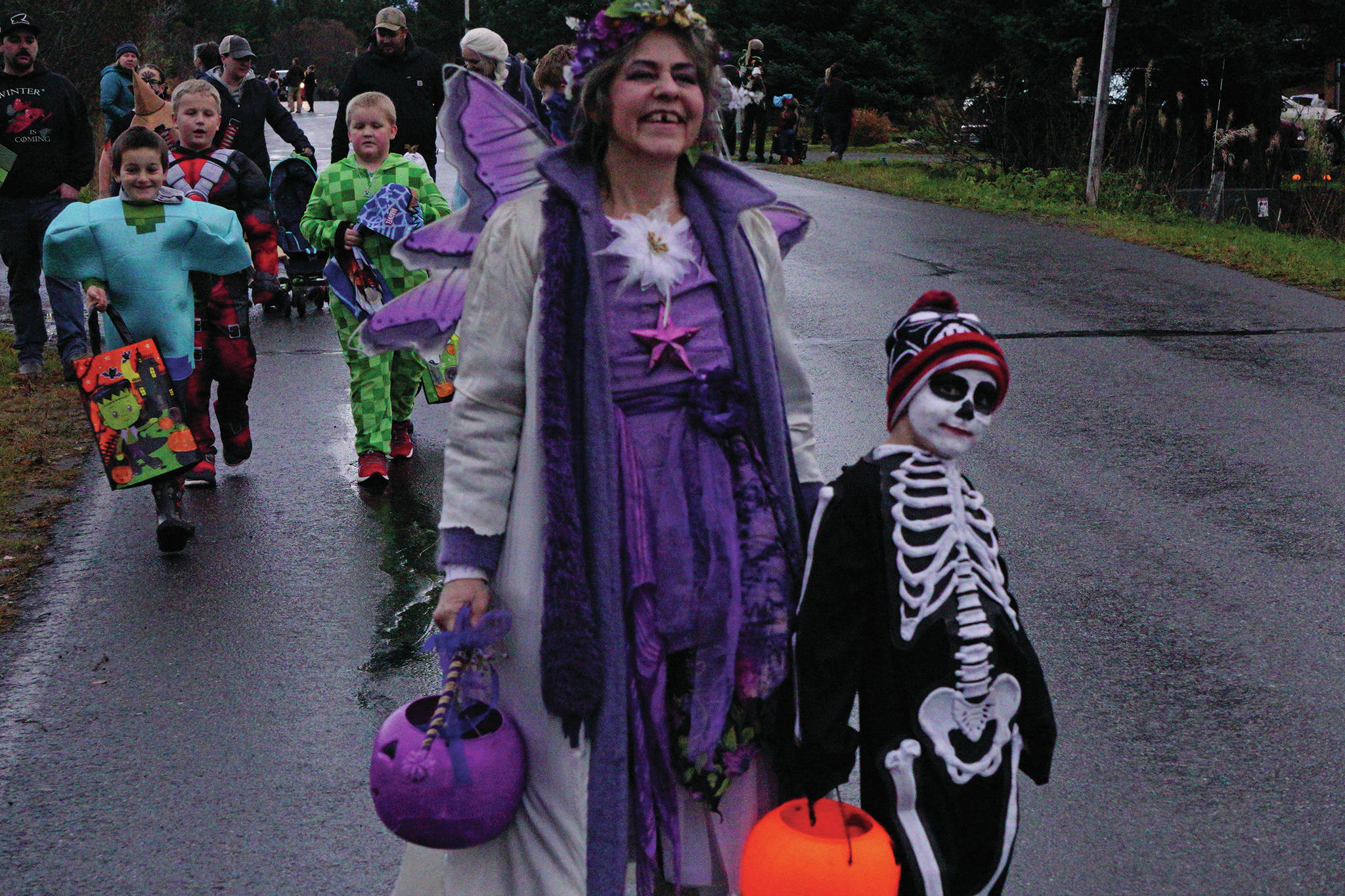 Tami Huston, left, and her granddaughter, Magle, are part of a group of Halloween trick-or-treaters walking down Bayview Avenue on Oct. 31, 2019, in Homer, Alaska. (Photo by Michael Armstrong/Homer News)