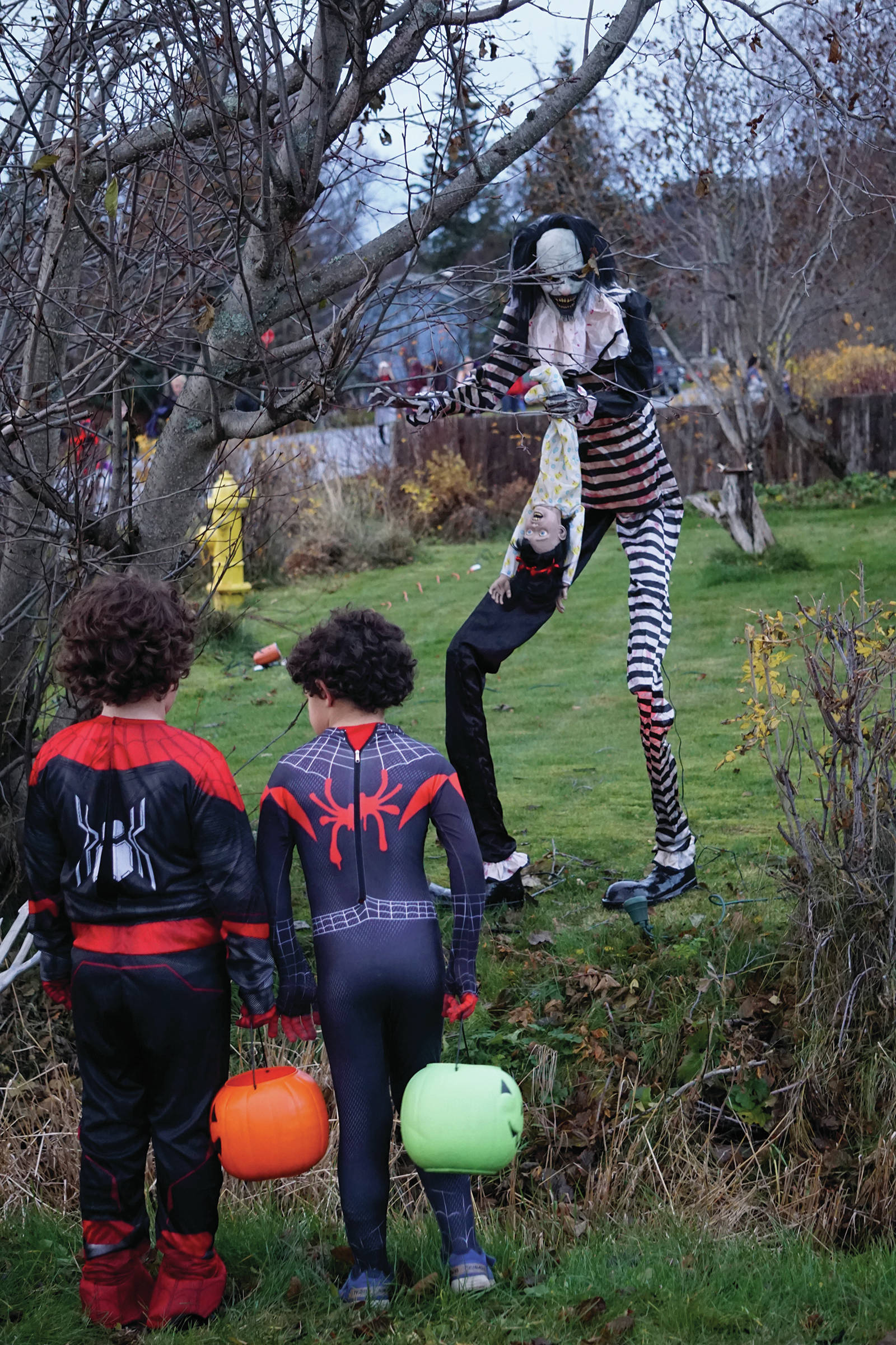 Halloween trick-or-treaters look at decorations at the Sean and Sandra Perry home on Oct. 31, 2019, in Homer, Alaska. (Photo by Michael Armstrong/Homer News)