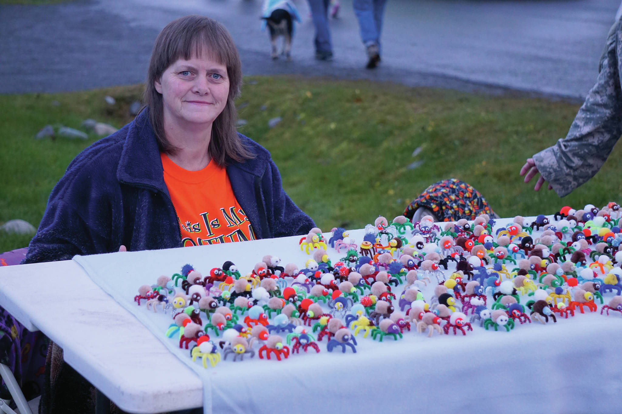 Molly Graham hands out pipecleaner spiders she made on Bayview Avenue on Oct. 31, 2019, in Homer, Alaska. (Photo by Michael Armstrong/Homer News)