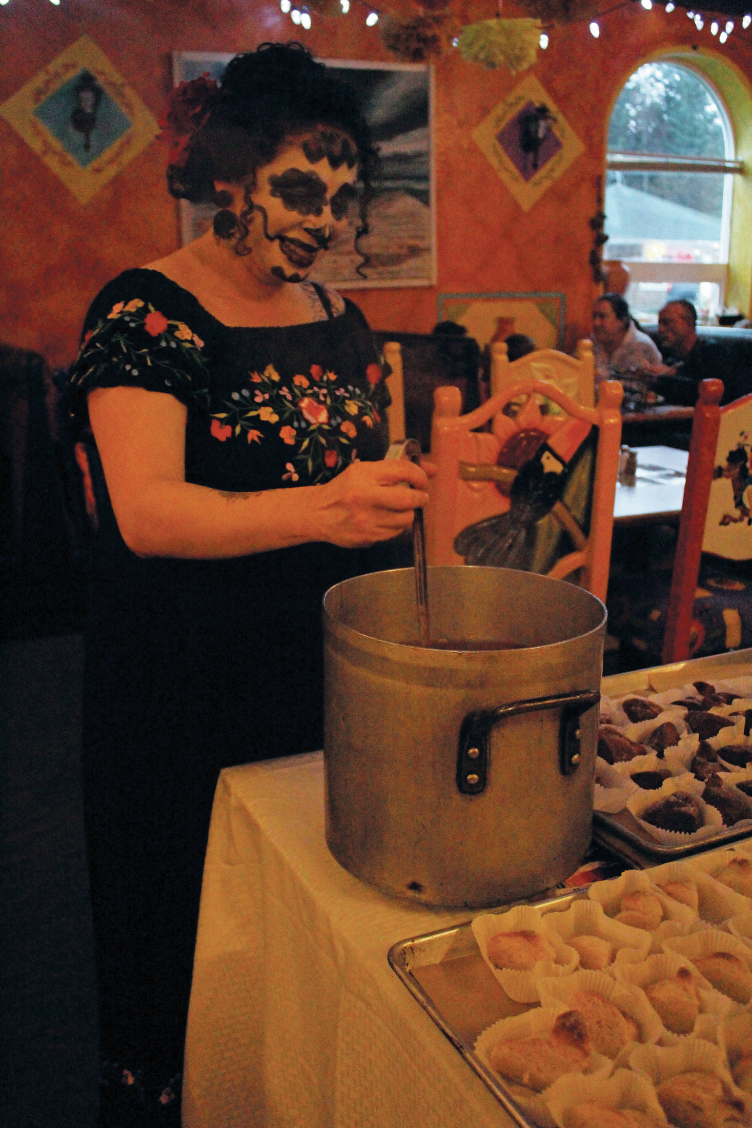 Evangelina Briggs of Homer Truffle Co. stirs drinking chocolate at a Dia de los Muertos celebration Saturday, Nov. 2, 2019 at Don Jose’s Mexican Restaurant in Homer, Alaska. (Photo by Megan Pacer/Homer News)