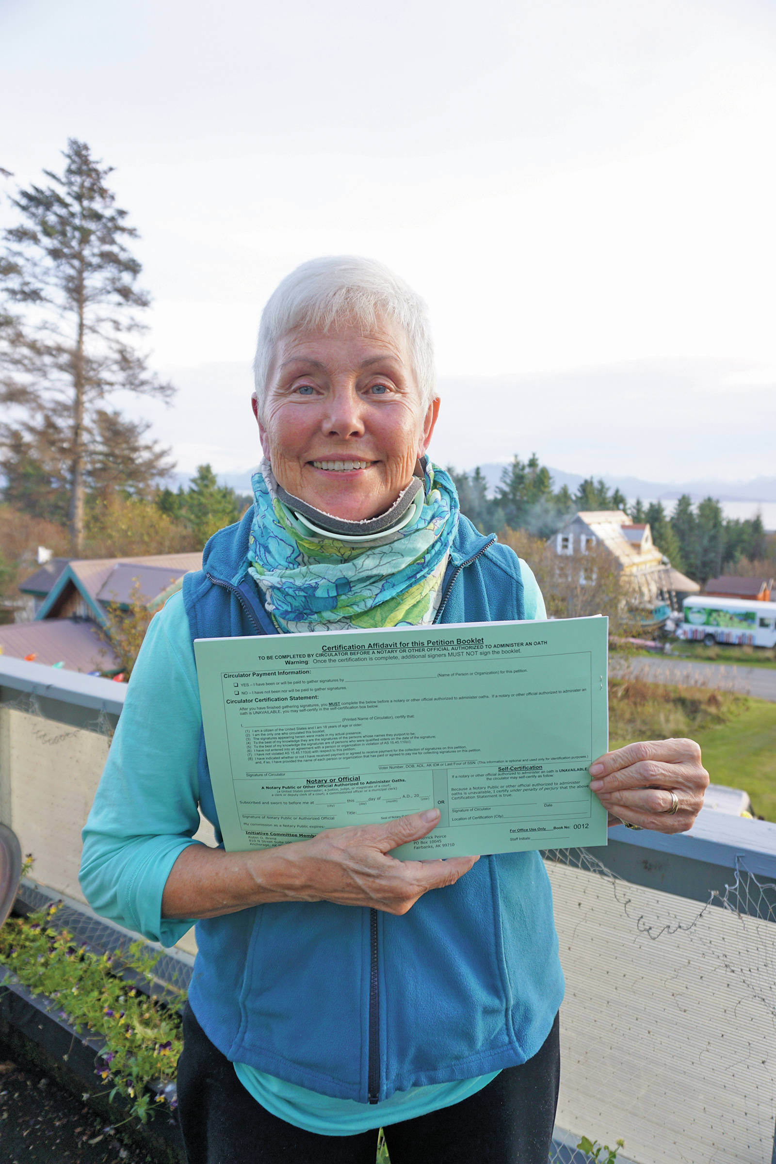 Fair Share Act sponsor Jane Angvik holds an initiative petition booklet she delivered to Homer, Alaska, on Oct 25, 2019. (Photo by Michael Armstrong/Homer News)