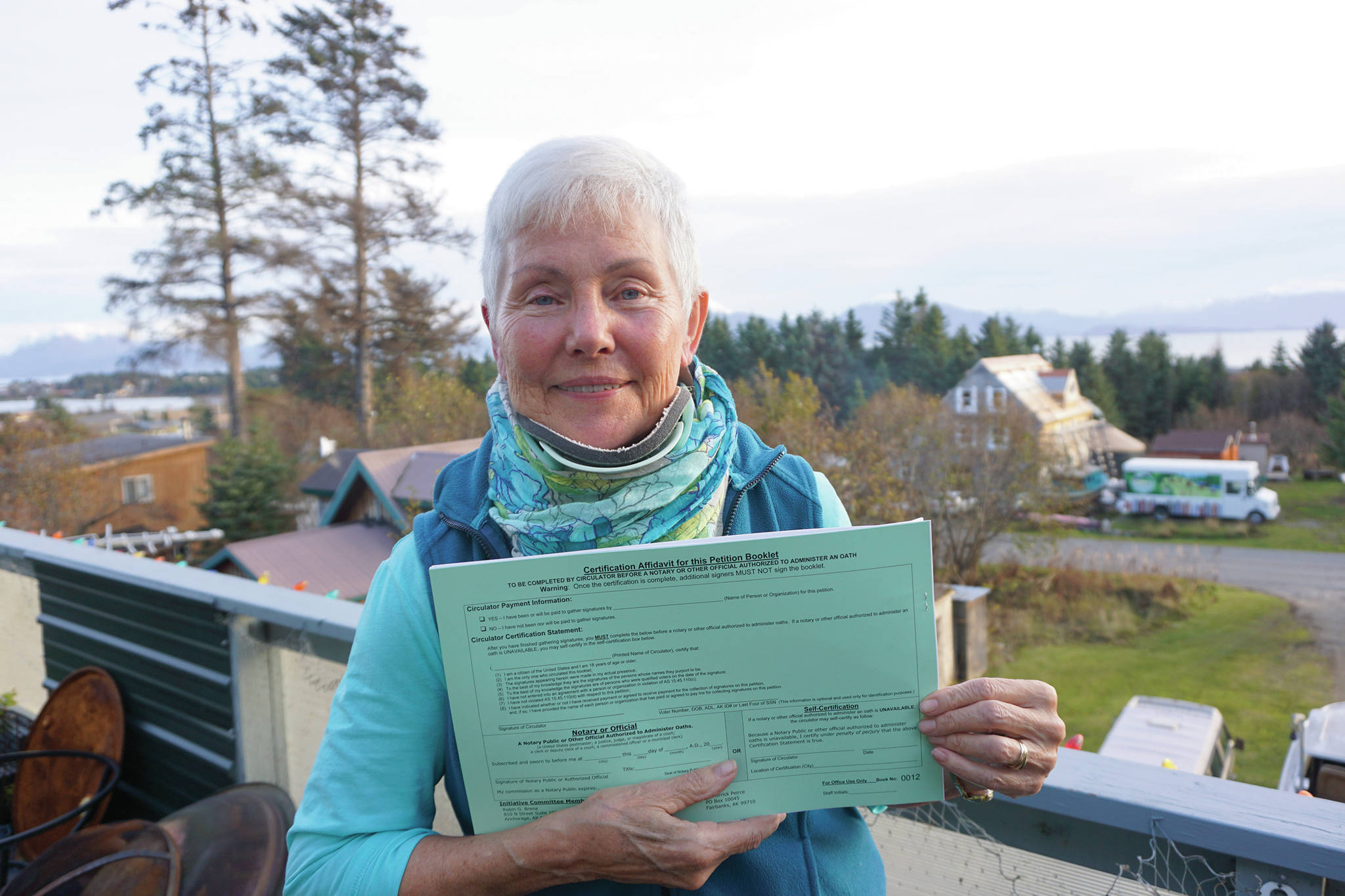 Fair Share Act sponsor Jane Angvik holds an initiative petition booklet she delivered to Homer, Alaska, on Oct. 25, 2019. (Photo by Michael Armstrong/Homer News)