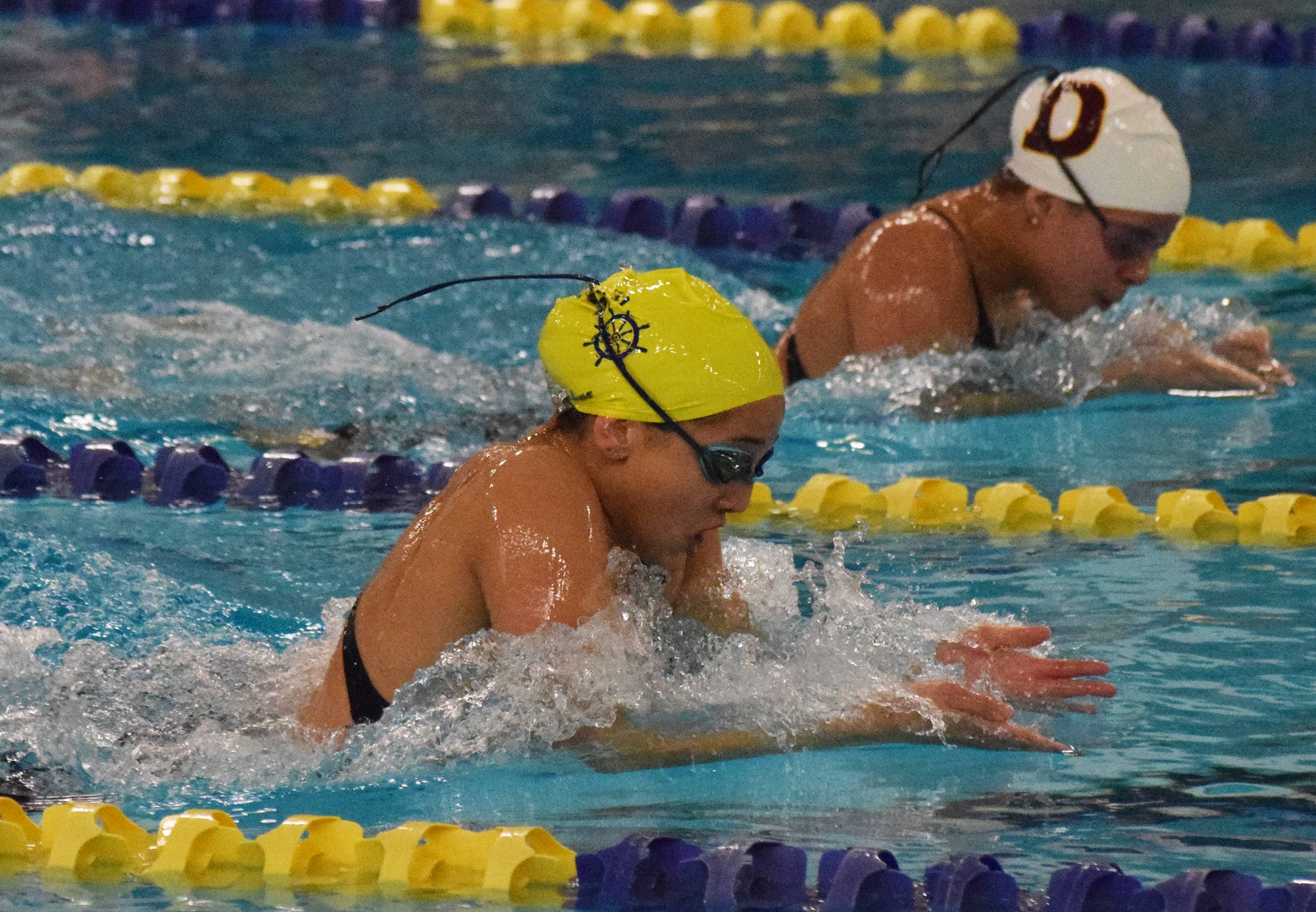 Homer’s Madison Story leads Dimond’s Dreamer Kowatch midway through the girls 200-yard IM final Saturday, Nov. 9, 2019, at the ASAA state swimming and diving championship at the Bartlett pool in Anchorage, Alaska. (Photo by Joey Klecka/Peninsula Clarion)
