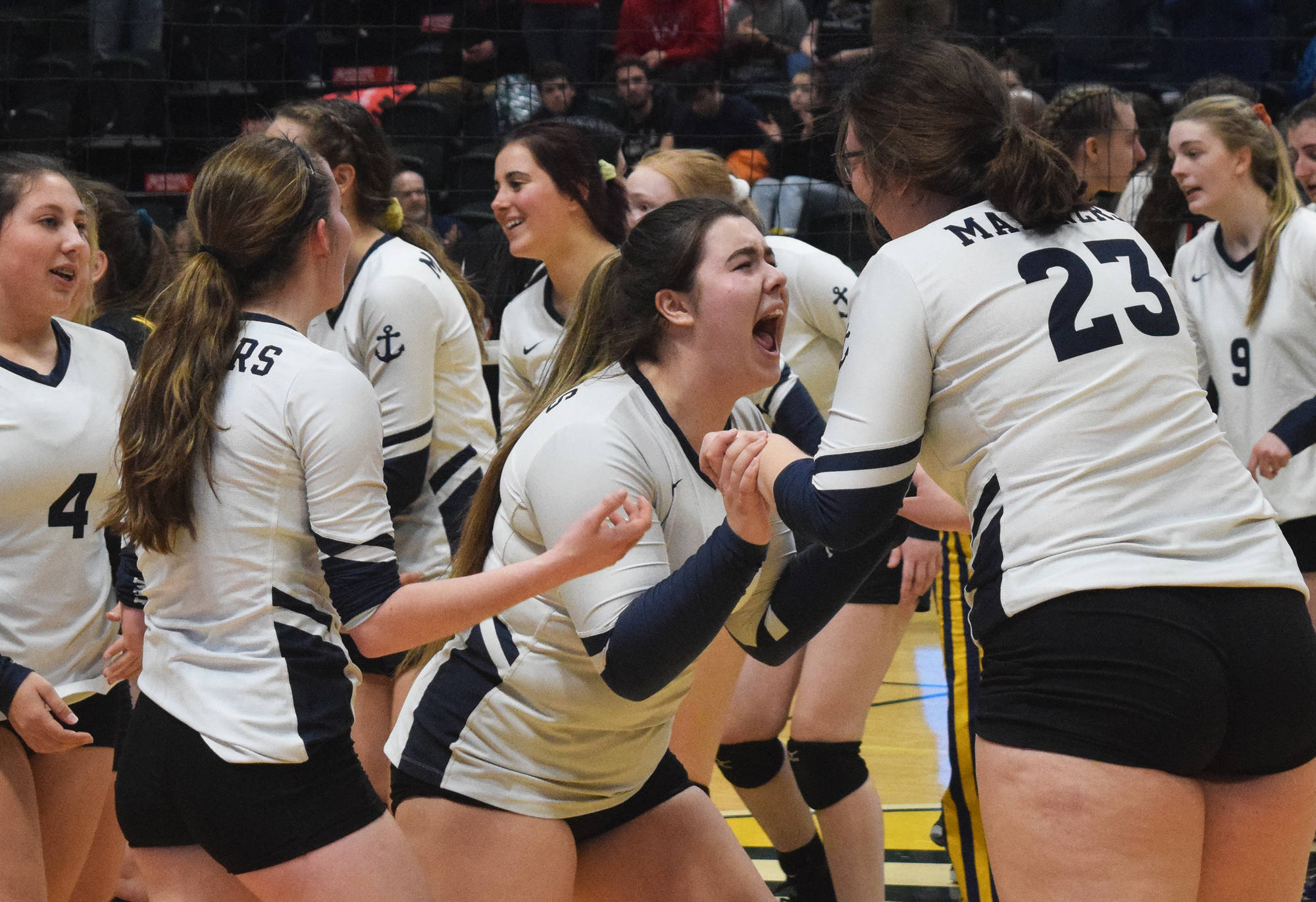 Homer teammate Katlyn Vogl (left) and Tonda Smude celebrate Saturday, Nov. 16, 2019, after winning the Class 3A state volleyball tournament at the Alaska Airlines Center in Anchorage, Alaska. (Photo by Joey Klecka/Peninsula Clarion)