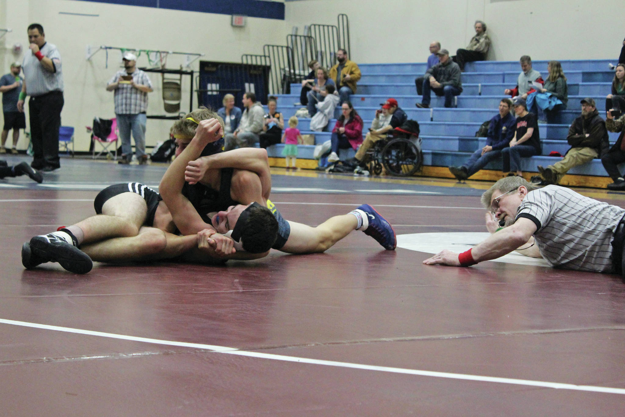 Homer’s Austin Cline attempts to pin Nikiski’s Joey Yourkowski during a dual meet between the two schools Friday, Nov. 22, 2019 at Soldotna High School in Soldotna, Alaska. (Photo by Cecilia Fitzpatrick)