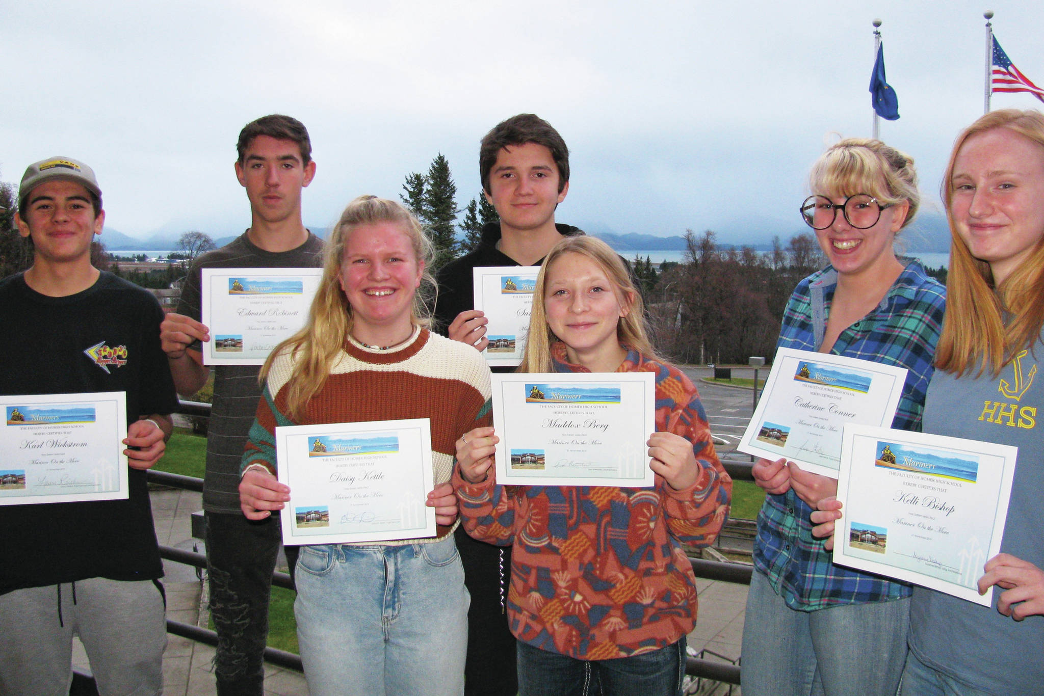 From left to right: Karl Wickstrom, Eddie Robinett, Daisy Kettle, Sam Cary, Maddox Berg, Catherine Conner and Kelli Bishop pose for a photo after being awarded this quarter’s Mariners on the Move in this undated photo at Homer High School in Homer, Alaska. Not pictured: Skyler Rodriguez. (Photo courtesy Paul Story)