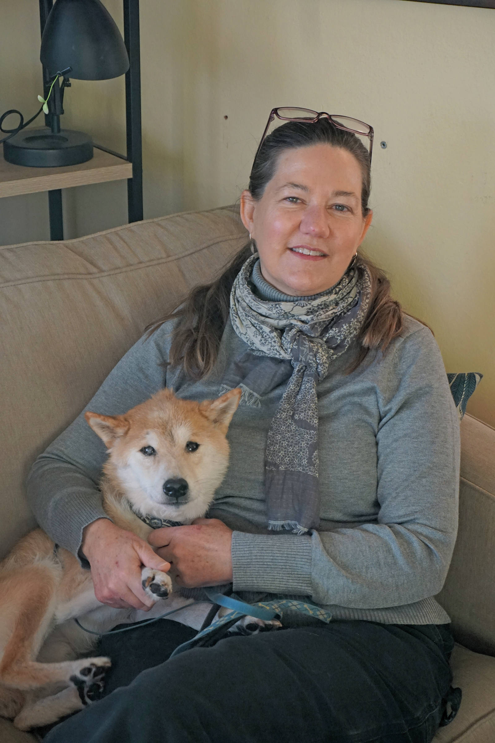 New Pratt Museum Executive Director Jennifer Gibbins poses with her dog, Bo, at her new home on Nov. 21, 2019, in Homer, Alaska. (Photo by Michael Armstrong/Homer News)