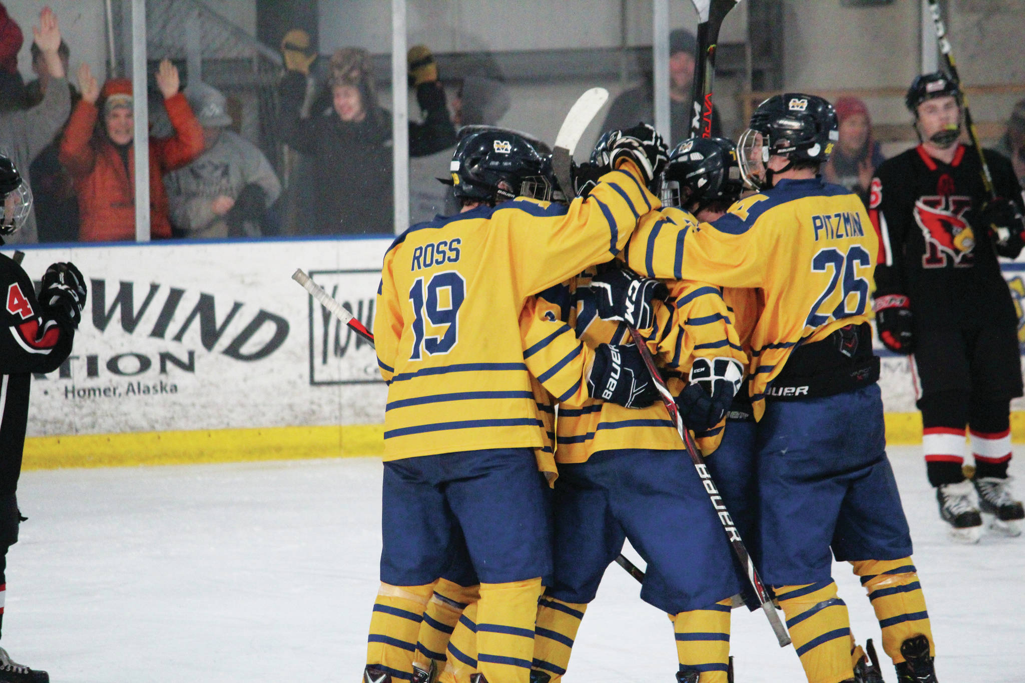The Mariners celebrate a goal during a Saturday, Nov. 23, 2019 hockey game against Kenai Central High School at Kevin Bell Arena in Homer, Alaska. (Photo by Megan Pacer/Homer News)