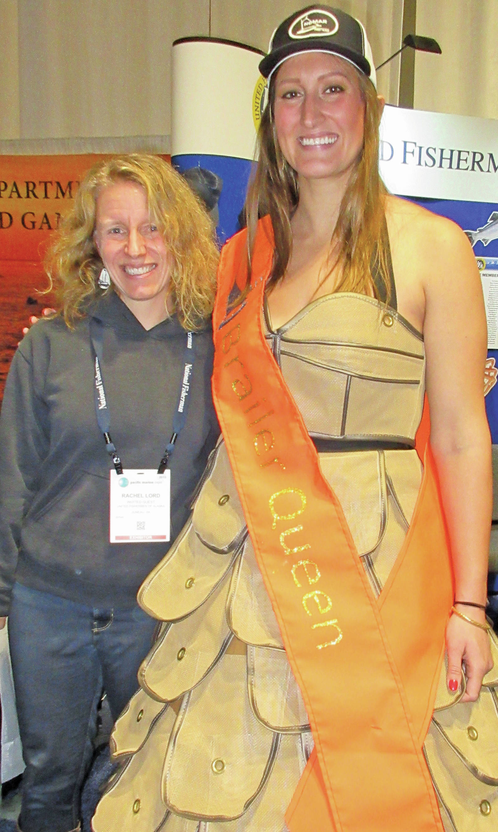 Homer City Council member Rachel Lord poses for a photo with fisherman Reba Temple, who walked through Pacific Marine Expo in a dress featuring NOMAR brailer bags and sewn by NOMAR employee Cassie Brooks, on Nov. 23, 2019, in Seattle. Lord attended the event as an invited guest of United Fishermen of Alaska. (Photo by McKibben Jackinsky)