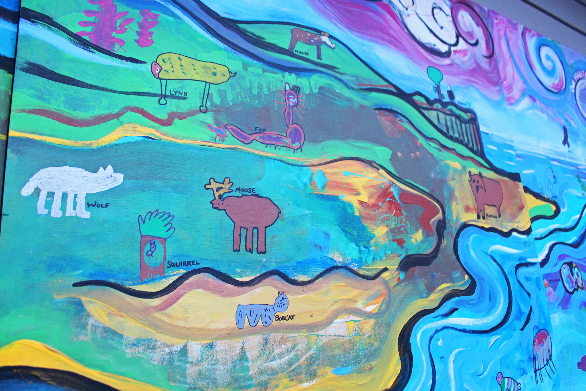 A mural of an Alaska habitat and animals painted by Fireweed Academy students is displayed on the outside of the school on East End Road on Friday, Nov. 22, 2019 in Homer, Alaska. Each quarter, students are creating a new mural to go along with a new education theme. (Photo by Megan Pacer/Homer News)