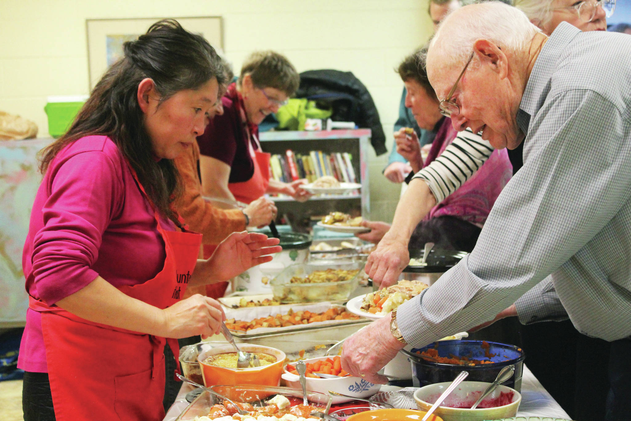 Volunteers serve a Thanksgiving meal to community members Thursday, Nov. 28, 2019 at Homer United Methodist Church in Homer, Alaska. (Photo by Megan Pacer/Homer News)
