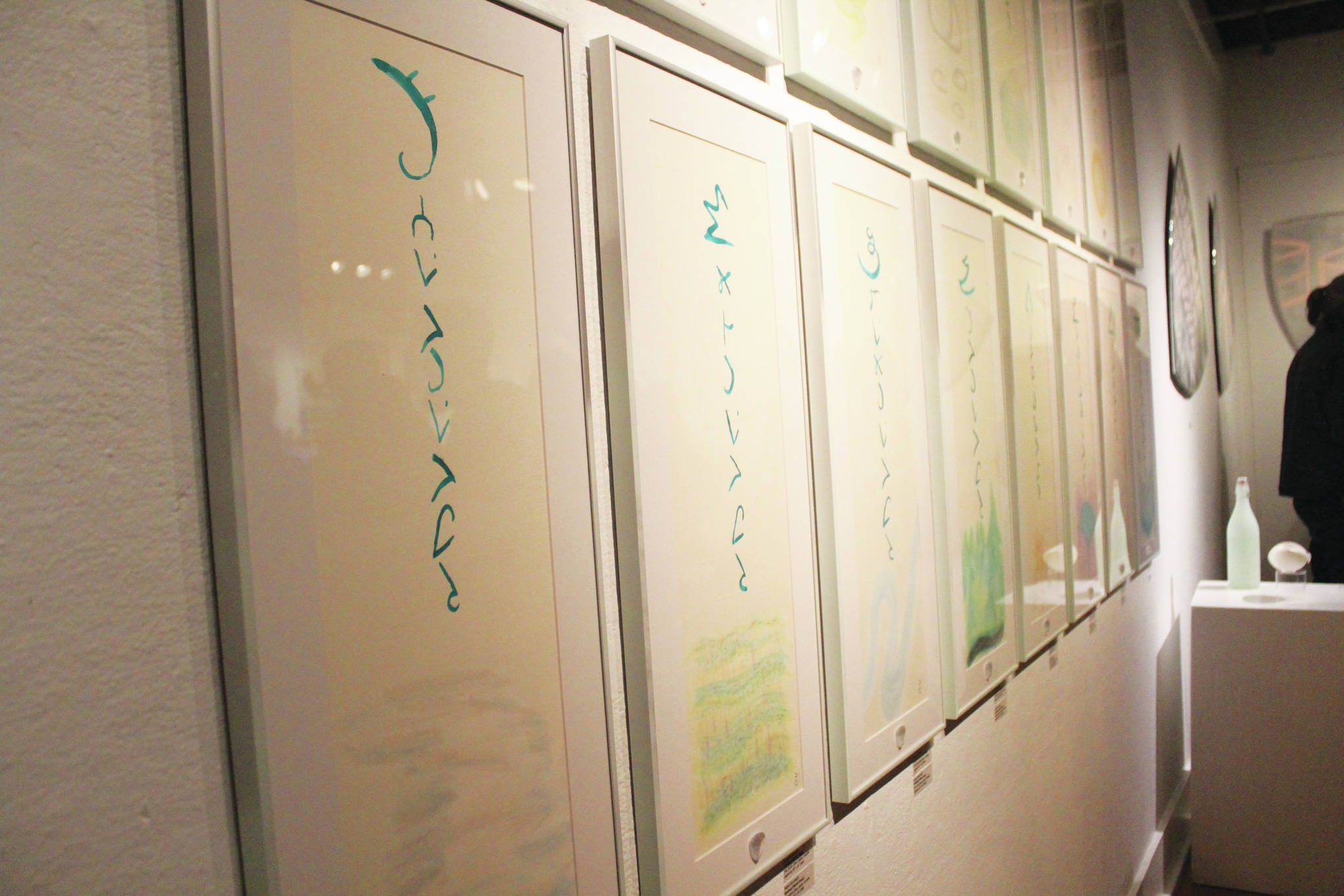 Paintings called Dnayi scrolls hang on a wall at the Bunnell Street Arts Center during an art exhibit opening Friday, Dec. 6, 2019 featuring the work of Argent Kvasnikoff in Homer, Alaska. The scrolls are calligraphic paintings depicting natural phenomena, like water or mountains. (Photo by Megan Pacer/Homer News)
