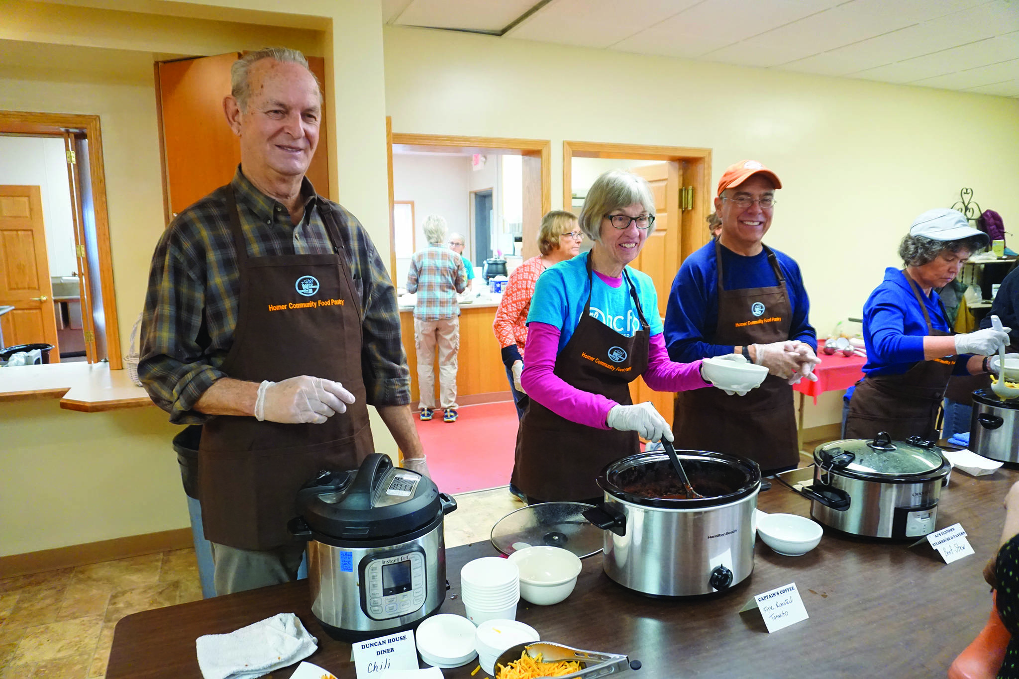 From left to right, Wim Steenbakkers, Deb Smith and Ray Quintana serve soup at the annual Homer Community Food Pantry’s Empty Bowls fundraiser on Friday, Nov. 8, 2019, at Homer United Methodist Church in Homer, Alaska. Quintana was visiting from Albuquerque, New Mexico, and volunteered his time during this stay. (Photo by Michael Armstrong/Homer News)