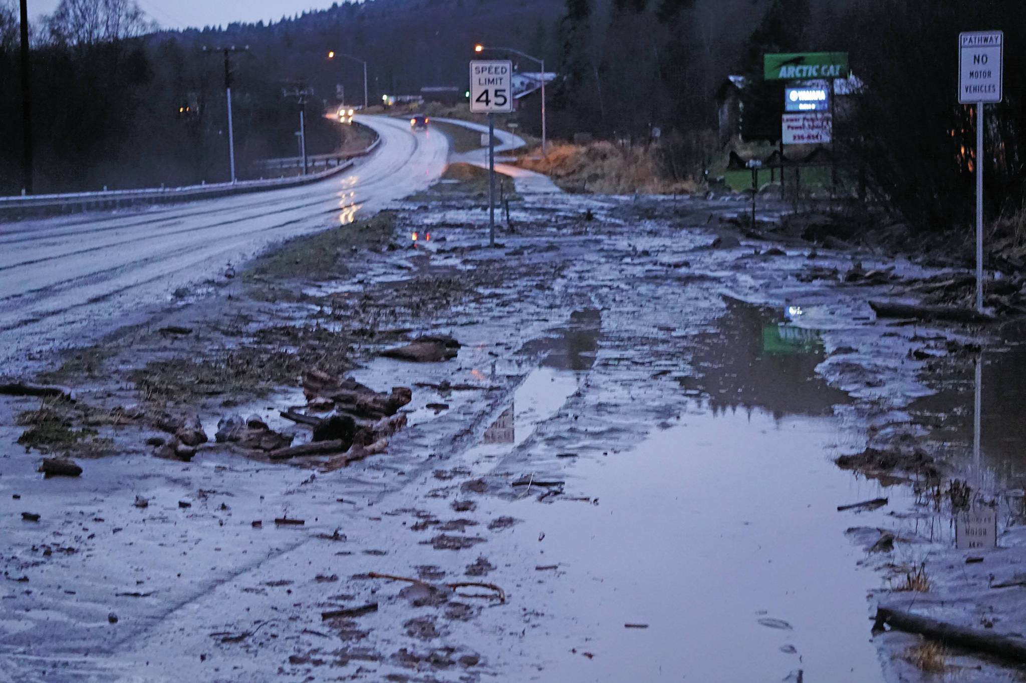Michael Armstrong / Homer News                                Mud and debris is washed up at Bear Creek near East End Road on Monday afternoon in Homer. Bear Creek crosses East End Road near Bear Creek Drive and overflowed the creek banks.