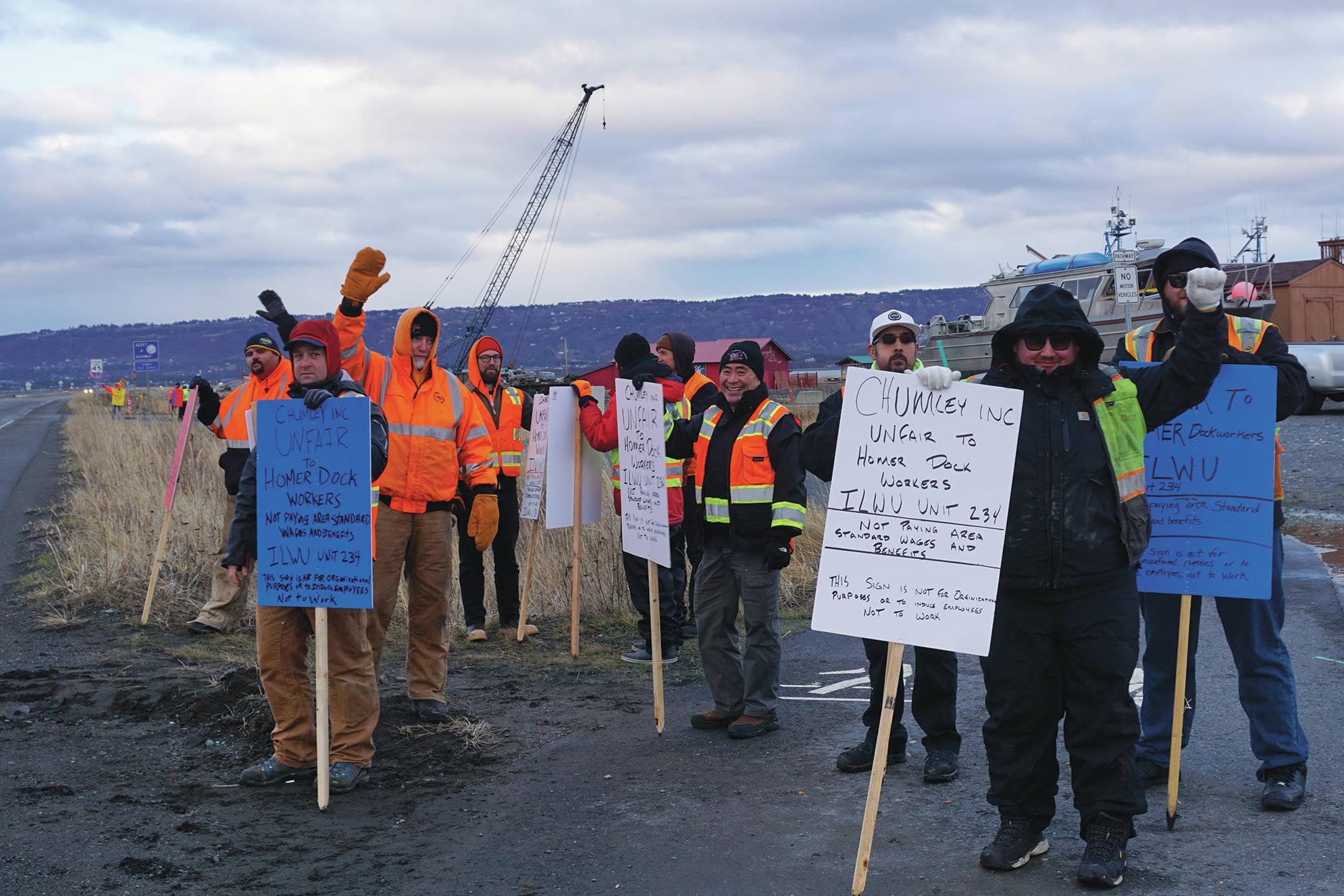 Longshore workers picket on the Homer Spit by Freight Dock Road on Tuesday, Dec. 17, 2019, in Homer, Alaska. They were part of a group of about 20 Alaska International Longshore and Warehouse Union members or supporters holding an “area standards” picket in response to Chumley’s Inc. use of workers to load a sulfur hauler ship the ILWU alleges are paid substandard wages. (Photo by Michael Armstrong/Homer News)