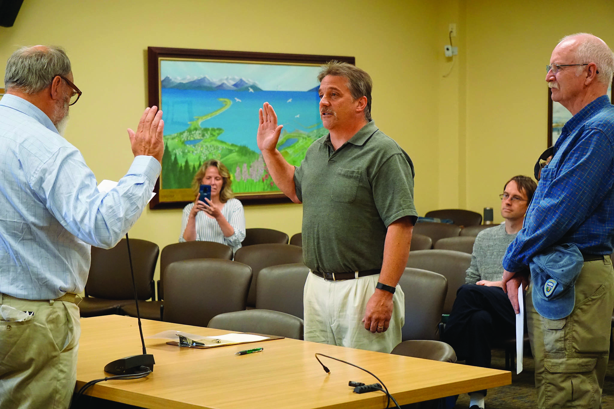 Homer Mayor Ken Castner, left, swears in new Homer Volunteer Fire Department Chief Mark Kirko, center, as former Acting Chief Robert Purcell, right, watches at the Homer City Council regular meeting held July 22, 2019, in the Cowles Council Chambers, Homer City Hall, in Homer, Alaska. Castner also read a letter of appreciation Painter, a former HVFD fire chief, thanking him for coming out of retirement to serve as acting chief. (Photo by Michael Armstrong/Homer News)