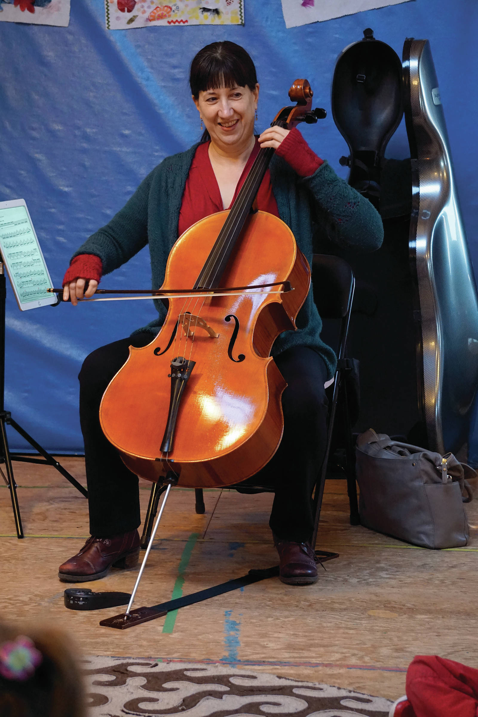 Nancy L. Ives, principal cellist for the Oregon Symphony Orchestra, Portland, plays for students at Little Fireweed Academy on Friday, Dec. 20, 2019, in Homer, Alaska. Ives talked with the students about cycles, a theme they have been studying this year, and how they fit in music. She also performed for a concert fundraiser at the Pratt Museum that night. (Photo by Michael Armstrong/Homer News)