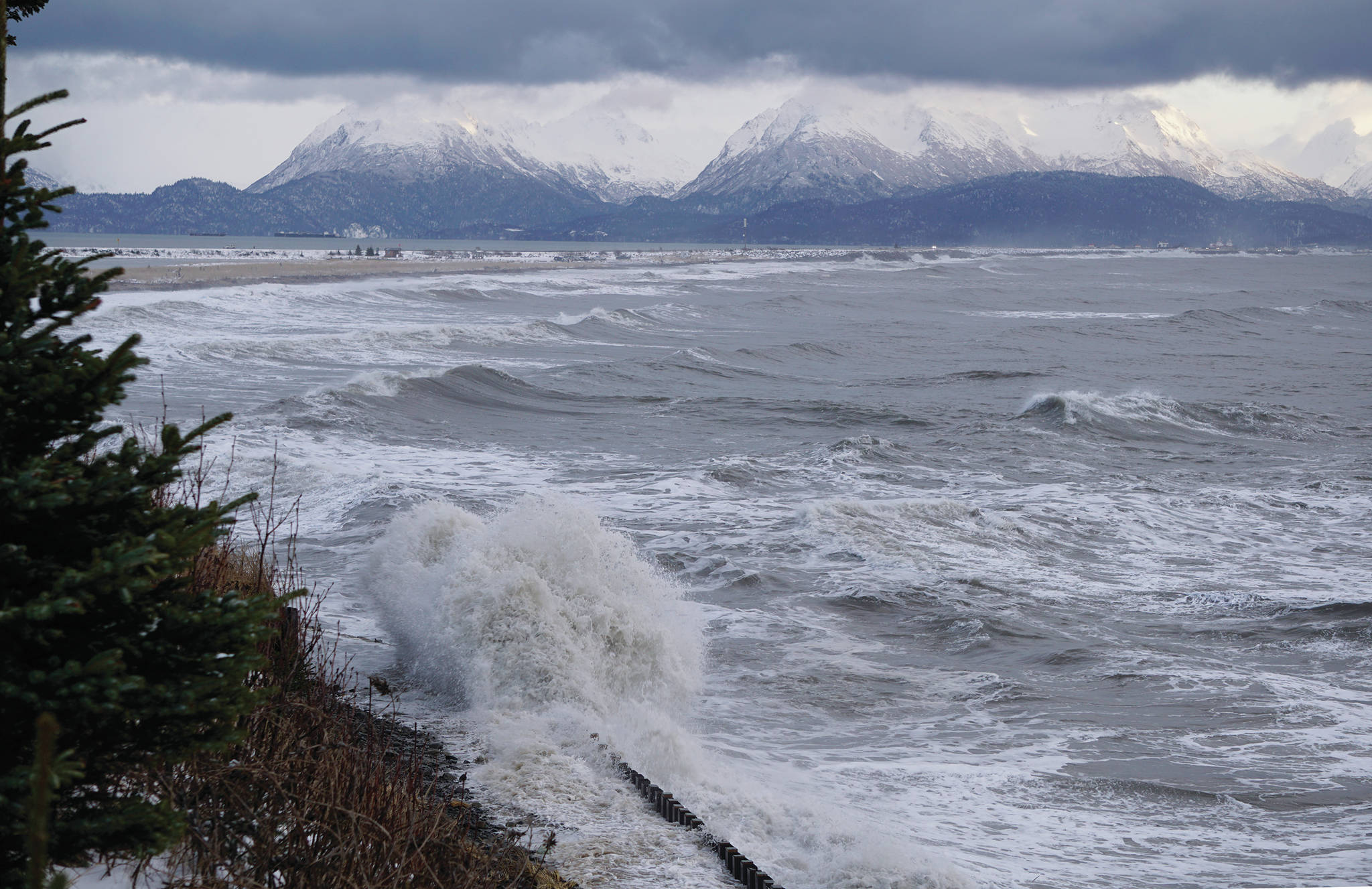 Waves crash against the Ocean Drive Loop seawall during a storm on the Homer Spit on Thursday, Dec. 26, 2019, in Homer, Alaska. The combination of a 20.7-foot high tide and swells out of the southwest hammered the north shore of Kachemak Bay. (Photo by Michael Armstrong/Homer News)