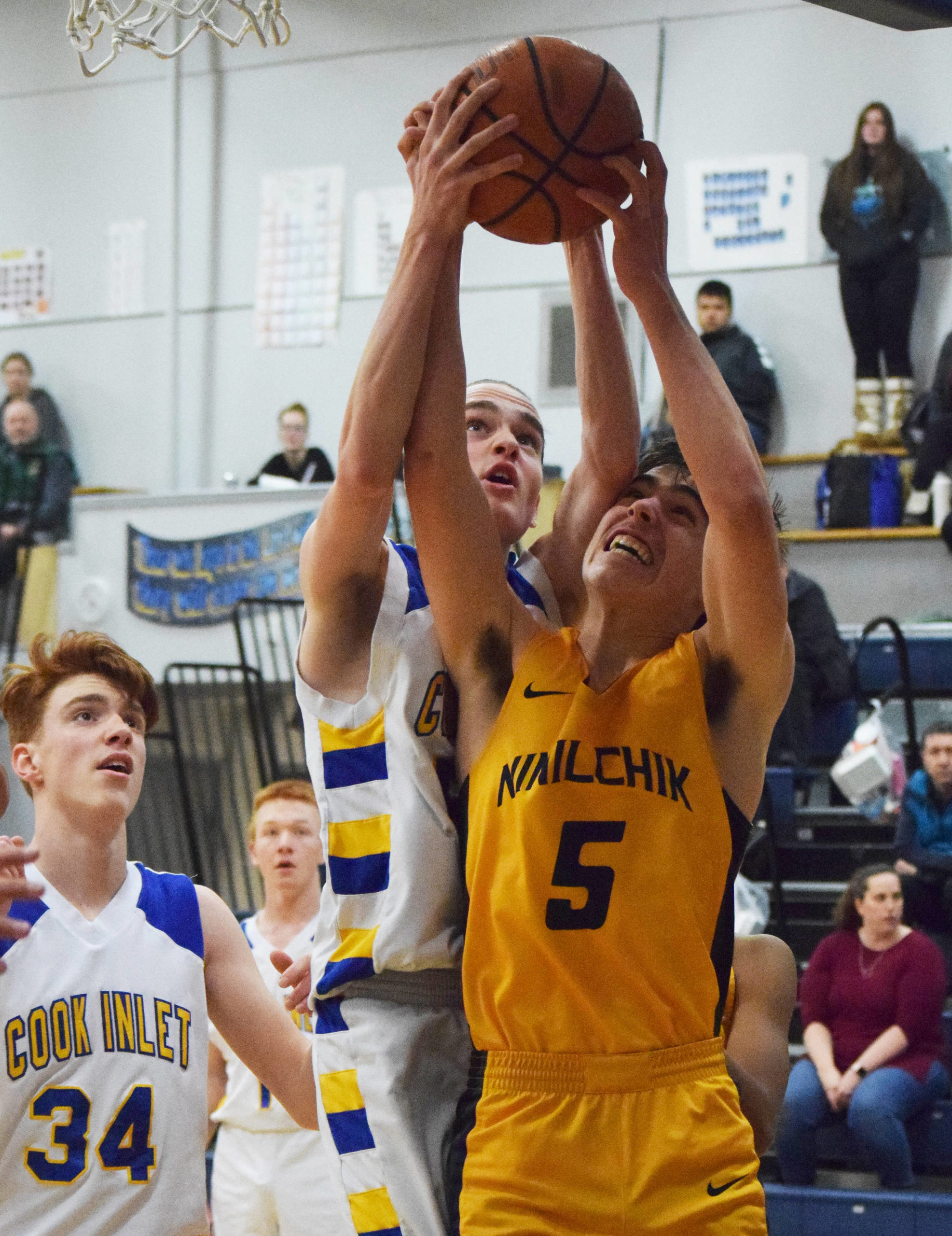 Ninilchik’s Tom Nelson (5) gets a block from CIA’s Josh Boyd, Tuesday, Jan. 7, 2020, at Cook Inlet Academy in Soldotna, Alaska. (Photo by Joey Klecka/Peninsula Clarion)