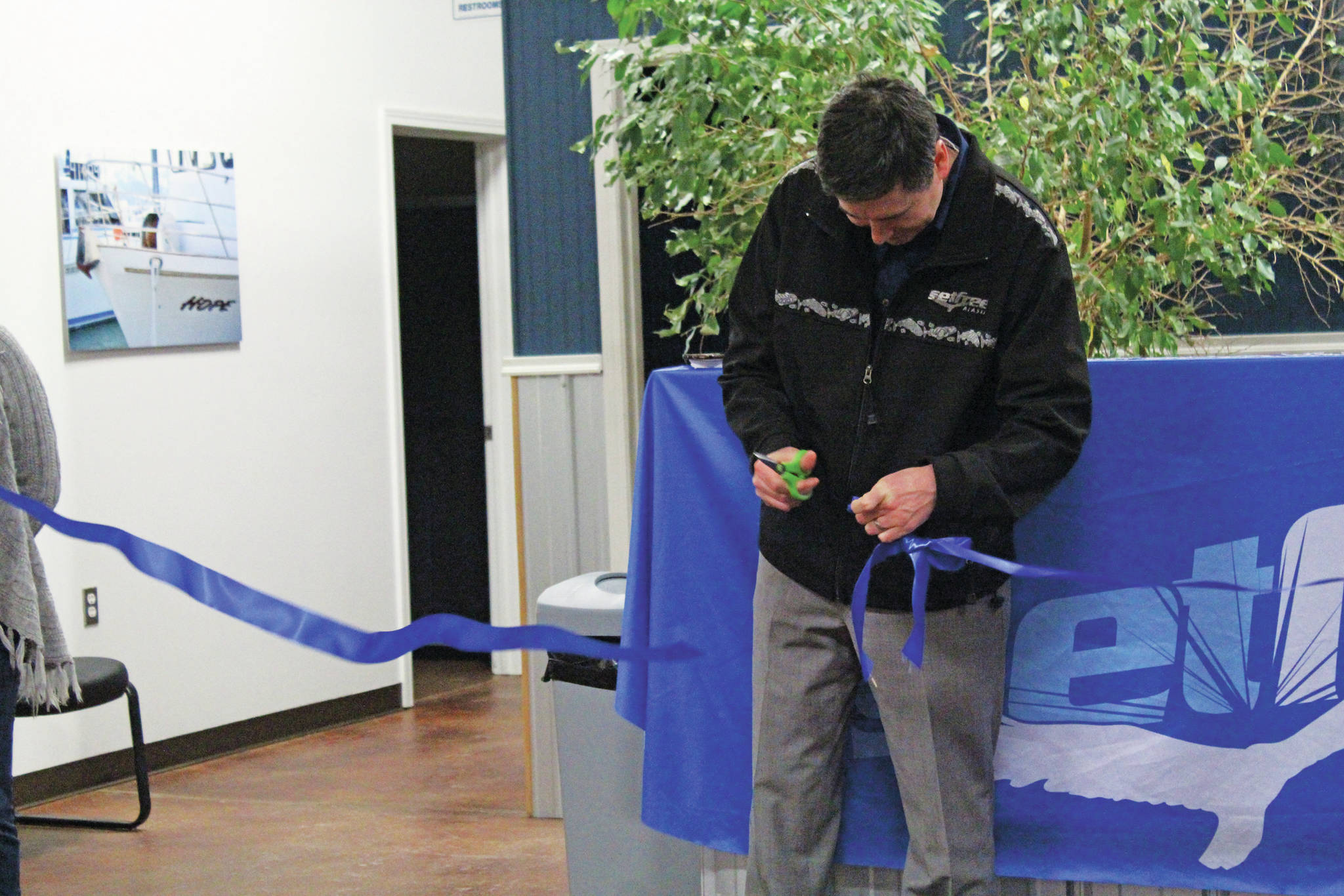 Josh Garvey, a member of Set Free Alaska’s board of directors, cuts the ribbon celebrating the opening of the faith-based addiction treatment nonprofit’s outpatient services building on Ocean Drive on Monday, Jan. 13, 2020 in Homer, Alaska. (Photo by Megan Pacer/Homer News)