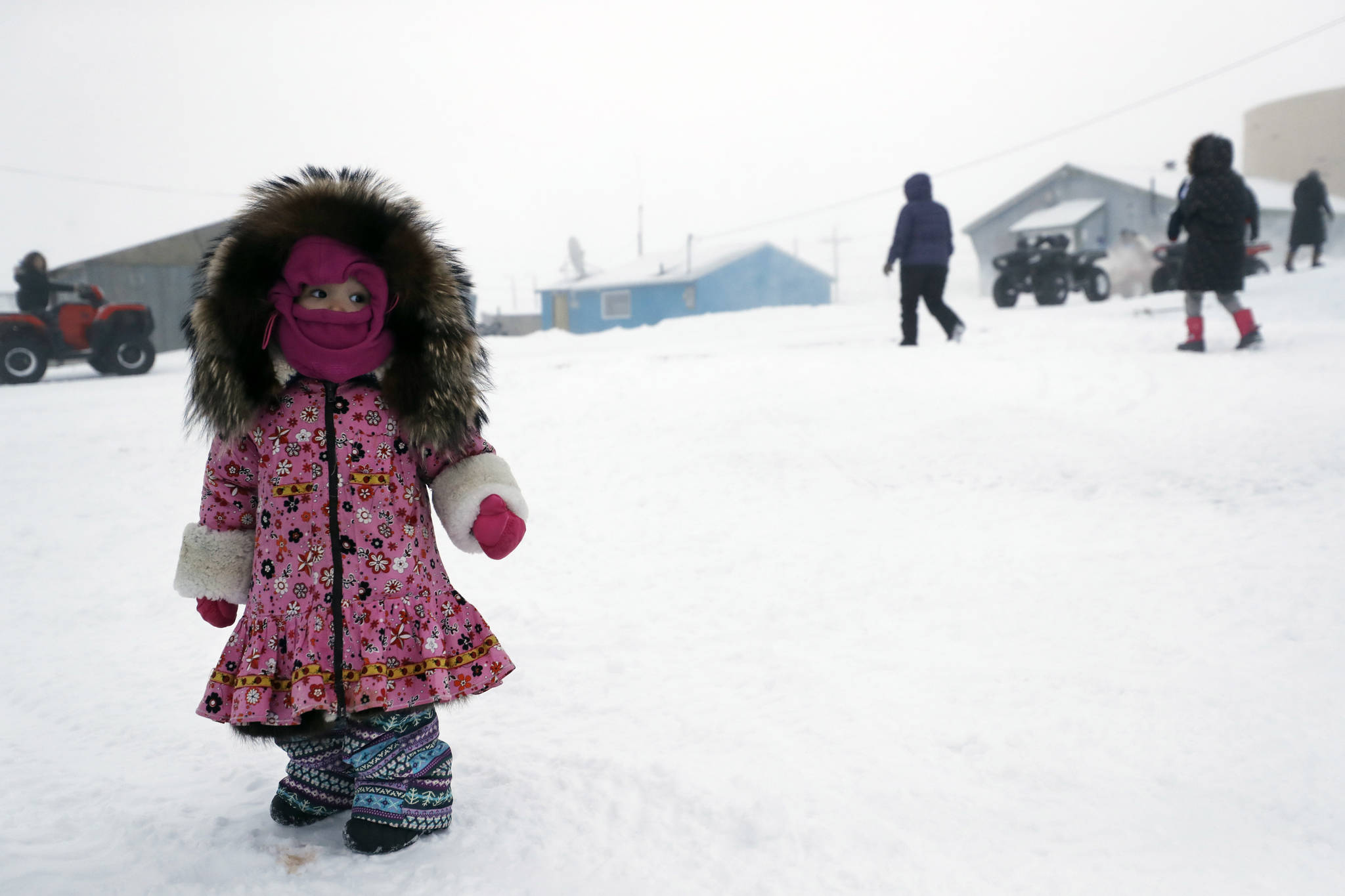 Gregory Bull | Associated Press                                A girl waits for her mother Sunday in Toksook Bay, Alaska.