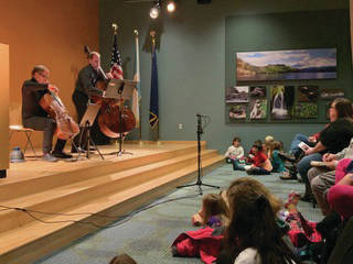 Enthralled kids enjoy the community concert with Low and Lower on Wednesday, Jan. 15, 2020 at Alaska Islands and Ocean Visitor Center in Homer, Alaska. (Photo courtesy Kim Fine)
