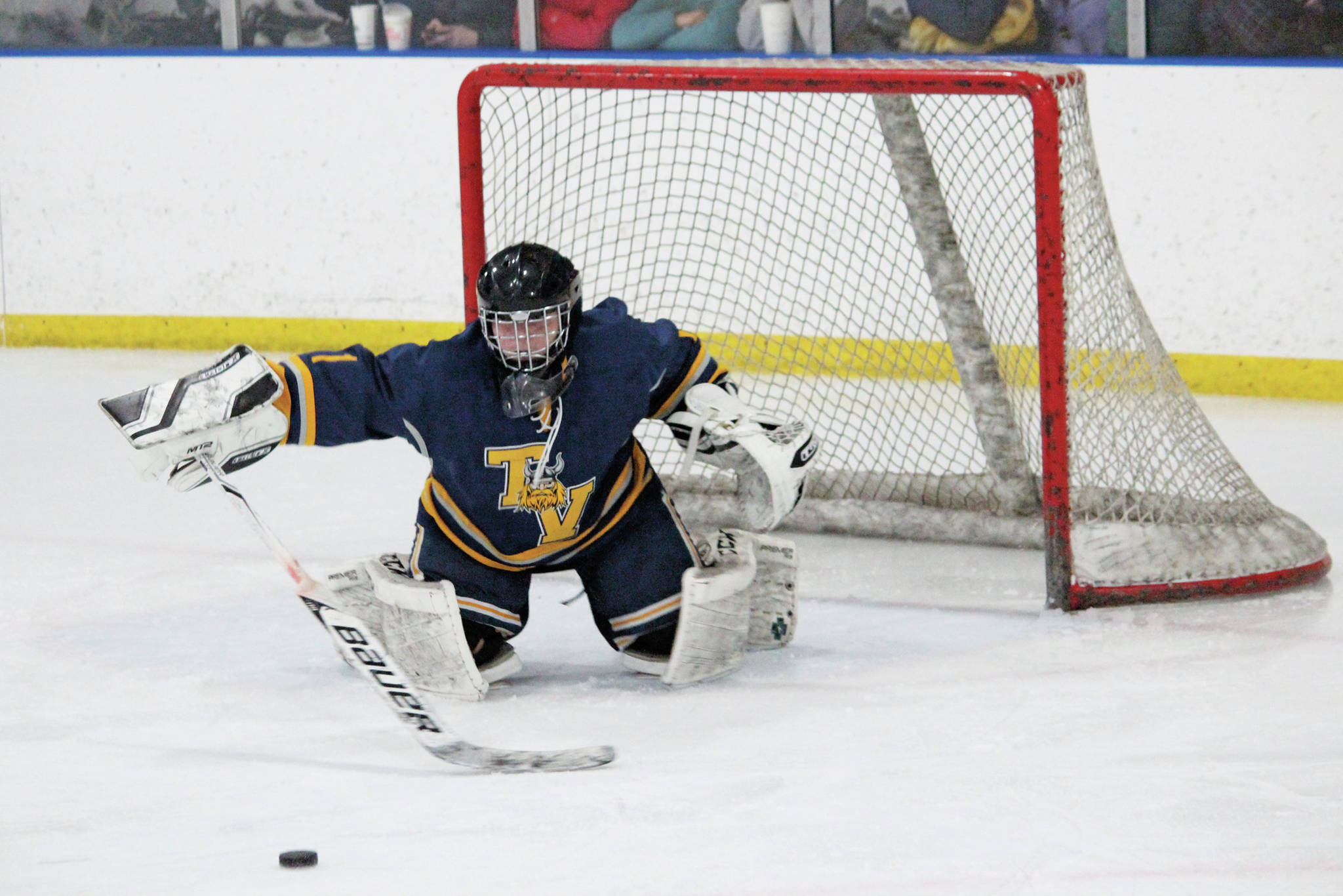 Tri-Valley School goaltender Danny Renshaw reaches out to block the puck during a Thursday, Jan. 30, 2020 hockey game against Homer High School at Kevin Bell Arena in Homer, Alaska. (Photo by Megan Pacer/Homer News)