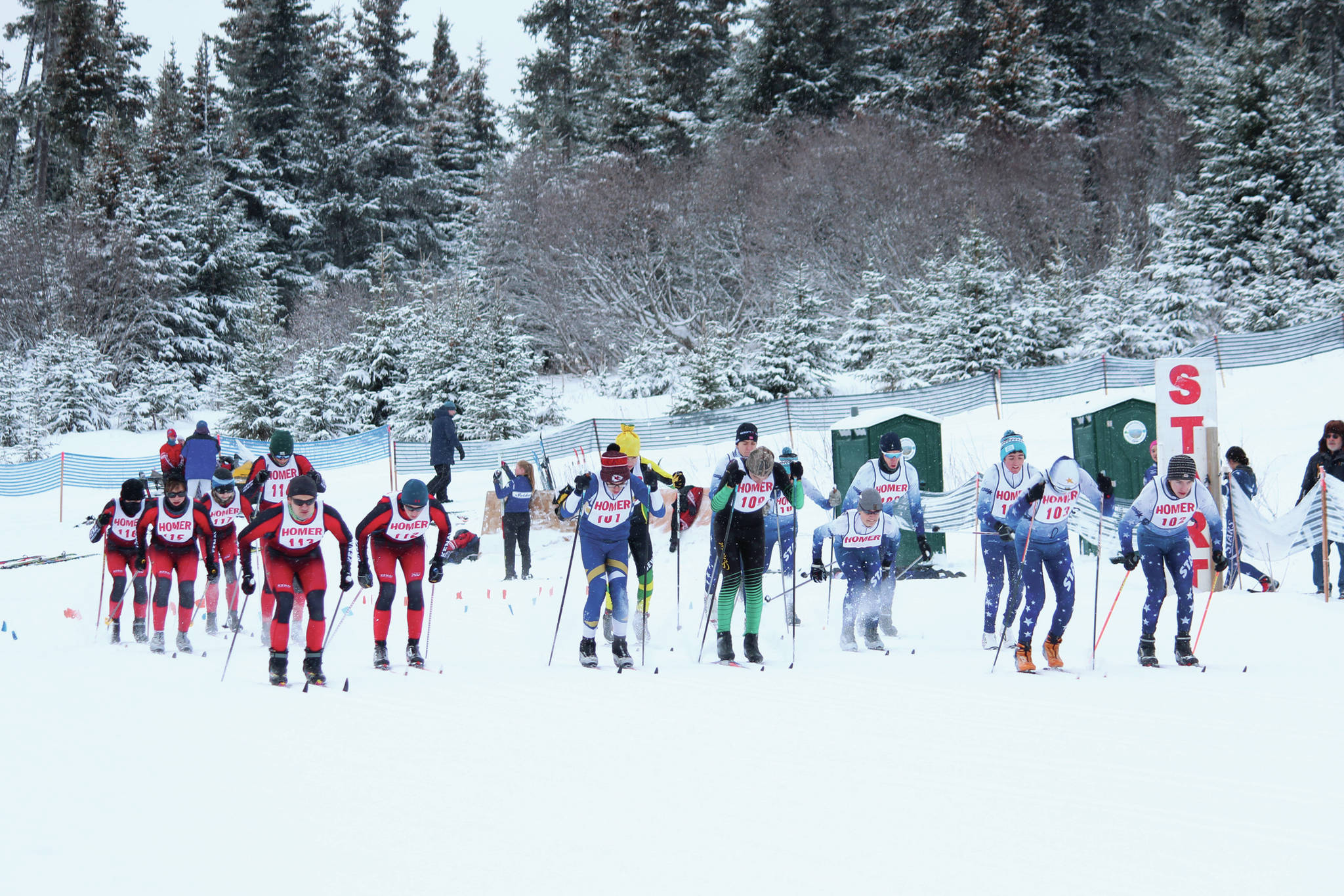 Varsity boy skiers from Kenai, Homer, Soldotna and Seward take off in the mass start 5-kilometer classic race Friday, Jan. 31, 2020 during the Homer Invite at the Lookout Mountain Trails on Ohlson Mountain Road near Homer, Alaska. (Photo by Megan Pacer/Homer News)