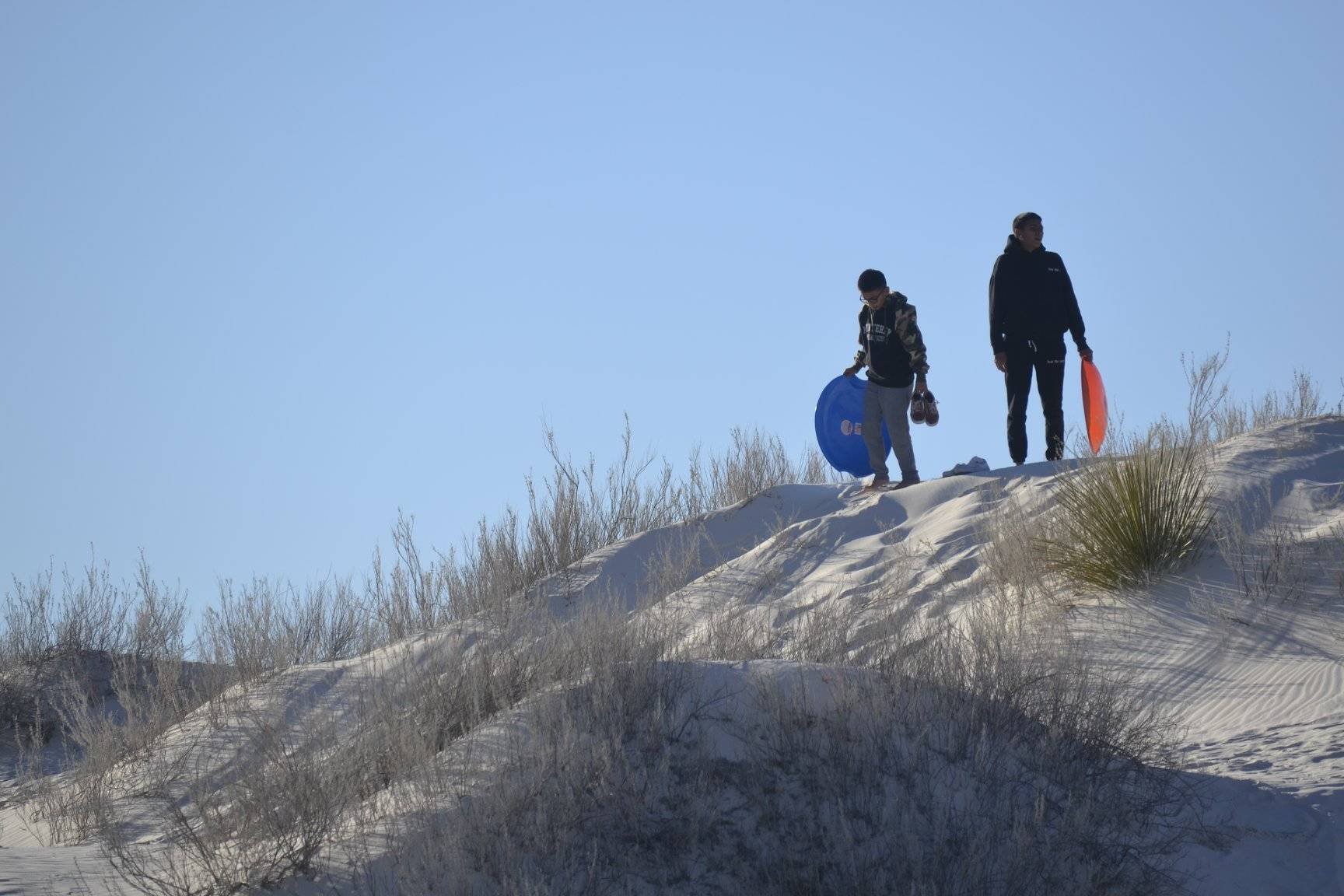 Sledders at White Sands National Monument in New Mexico. (Photo by Victoria Petersen/Peninsula Clarion)