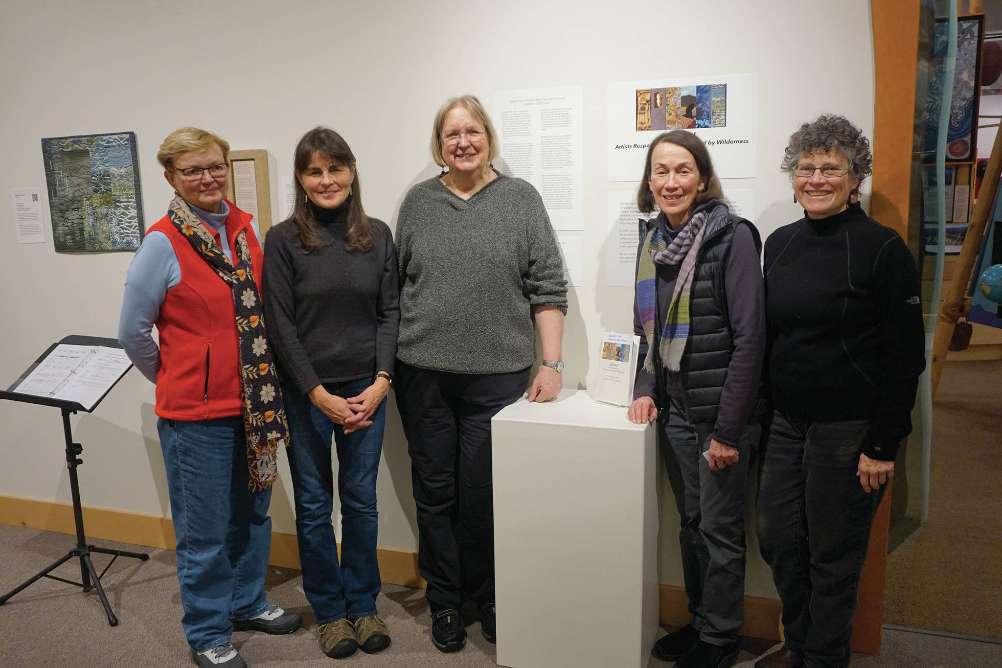 Five of the artists featured in “Denali Artists Respond to Music Inspired by Wilderness” pose for a photo on Feb. 4, 2020, at the Pratt Museum in Homer, Alaska. From left to right are Charlotte Bird, Susan Campbell, Ree Nancarrow, Margo Klass and Mary Bee Kaufman. Not pictured is Nancy Hausle-Johnson. The collaboration between artists and composers shows Feb. 7-May 25, 2020, at the Pratt. (Photo by Michael Armstrong/Homer News)