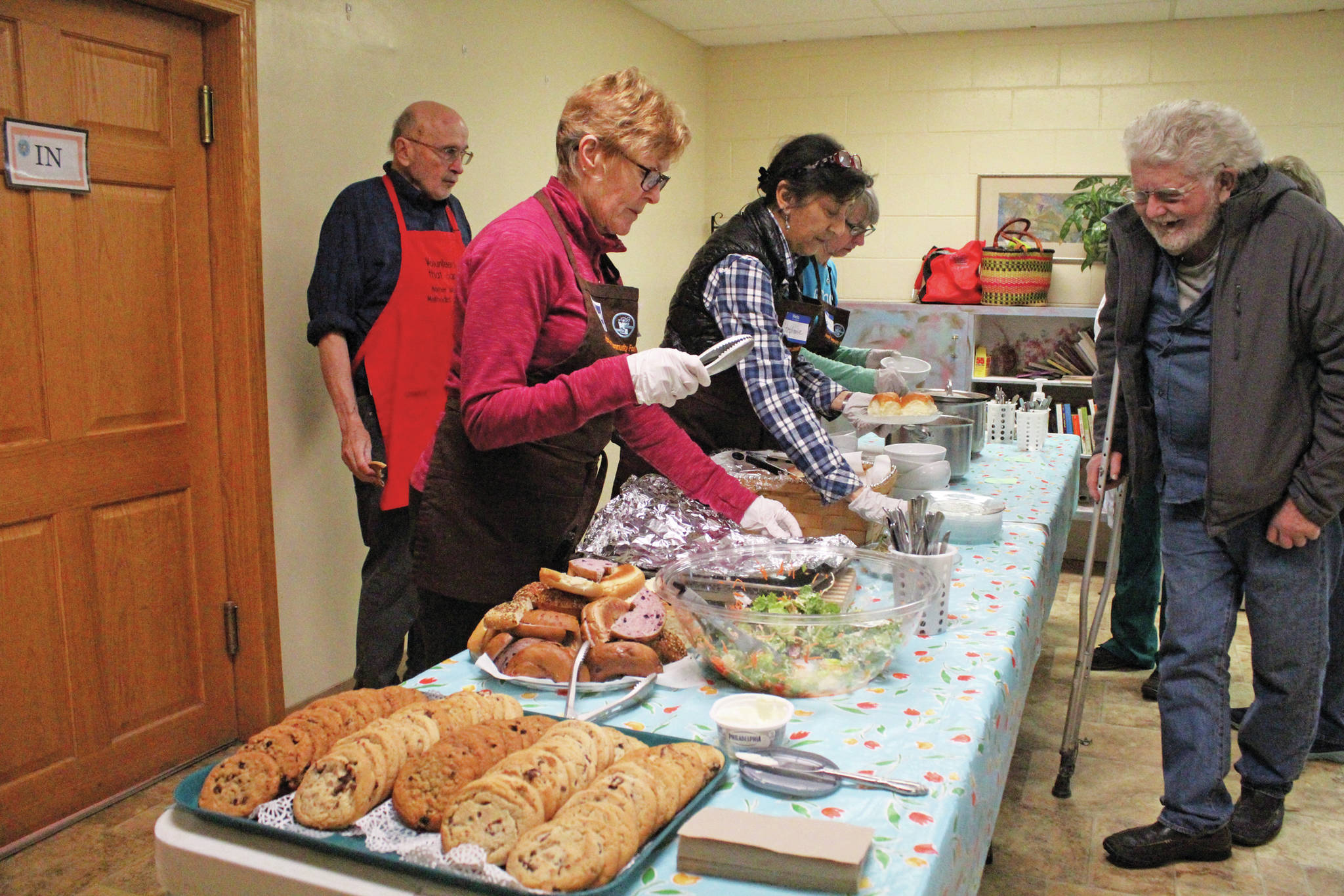 Volunteers distibute a meal to attendees at Project Homeless Connect on Jan. 29, 2020 at Homer United Methodist Church in Homer, Alaska. The event is a one-day opportunity for the homeless to get access to necessary supplies and services. (Photo by Megan Pacer/Homer News)